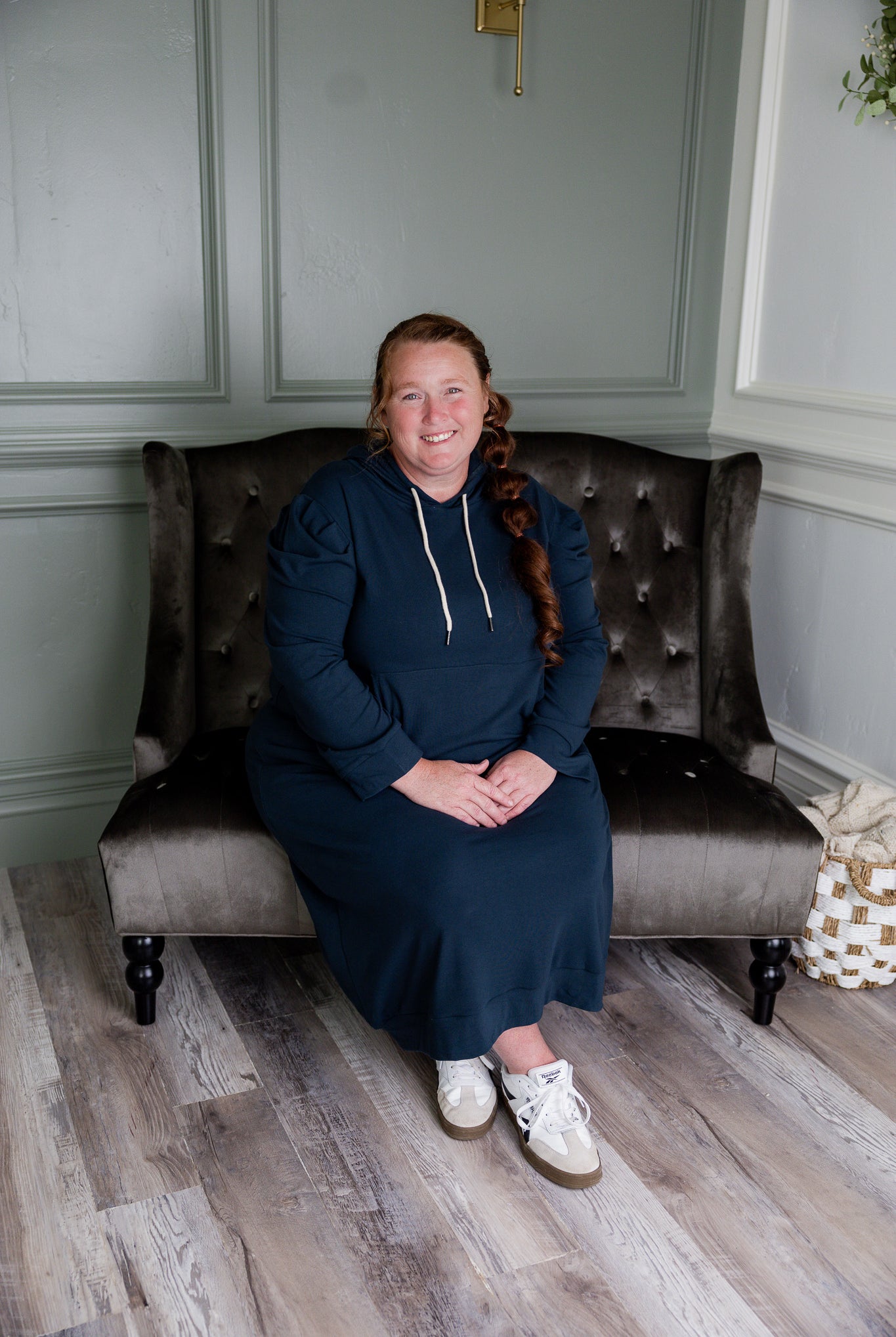 Model wearing Nuggles® Zoelle Dress in solid color, modest hoodie dress with puff sleeves.