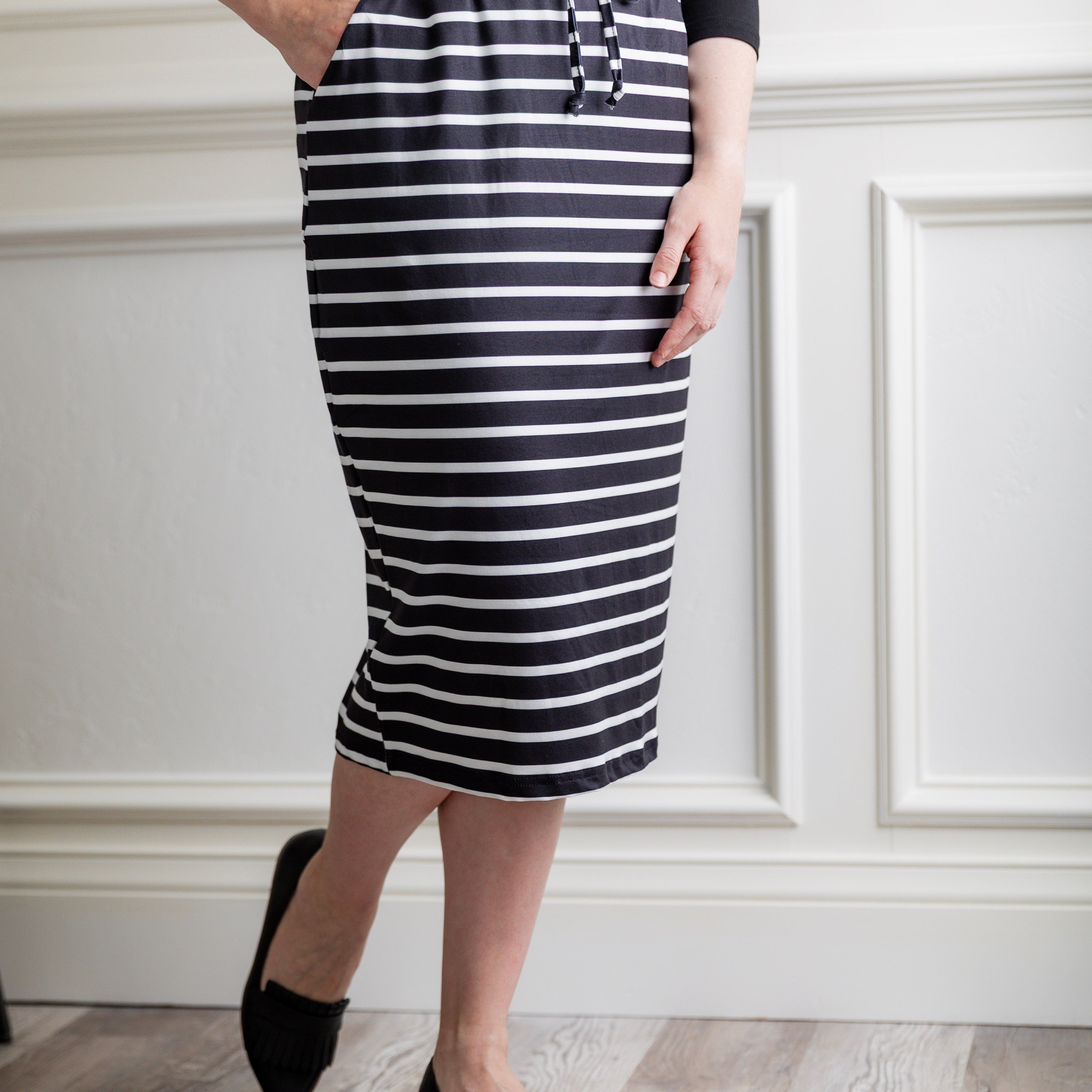 Woman wearing a modest 27-inch striped knit skirt in black and white with adjustable drawstring waistband.
