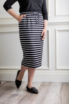Woman wearing a modest 27-inch striped knit skirt in black and white with adjustable drawstring waistband.