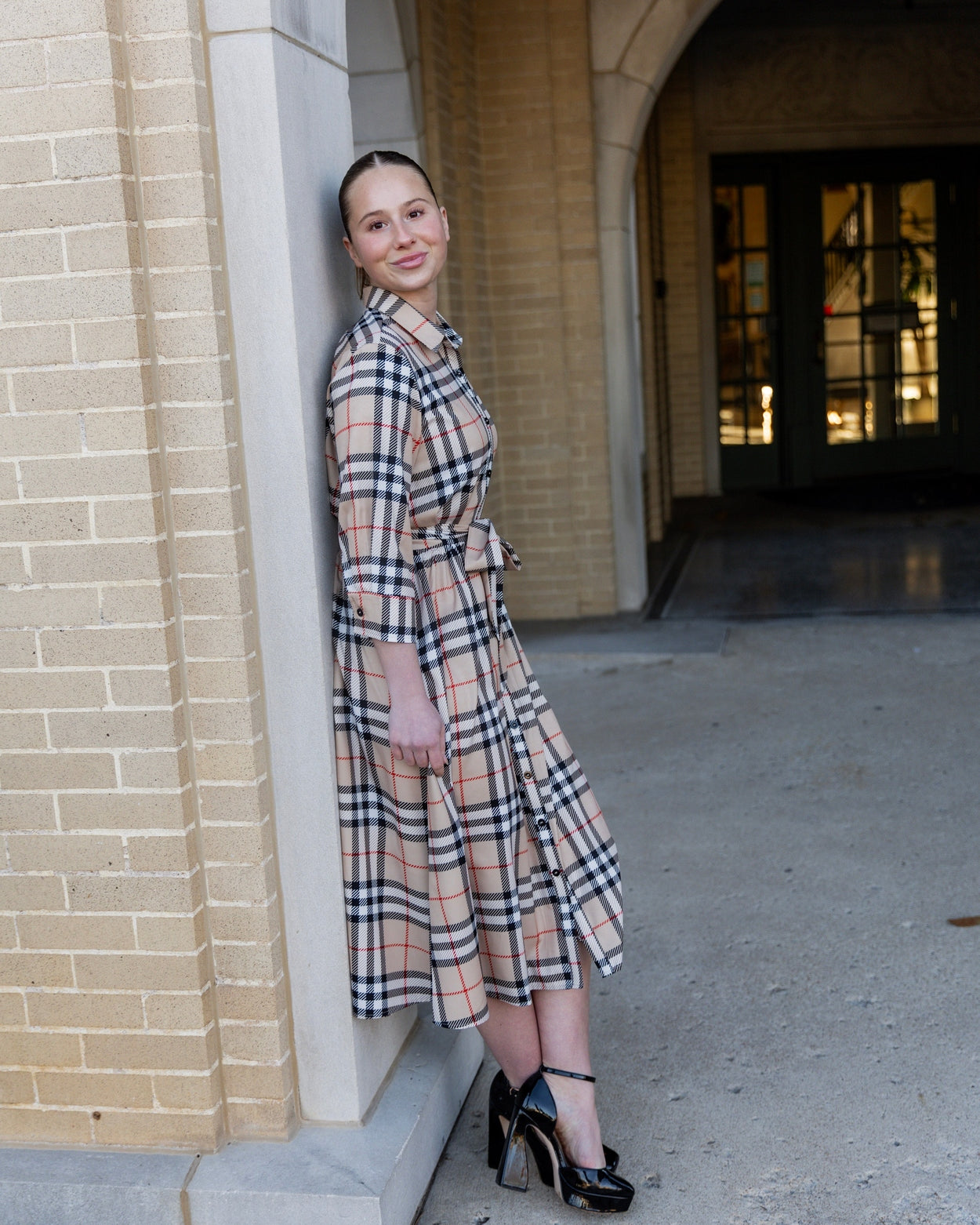 Model wearing the Nuggles® Rachel Dress in Sand Plaid