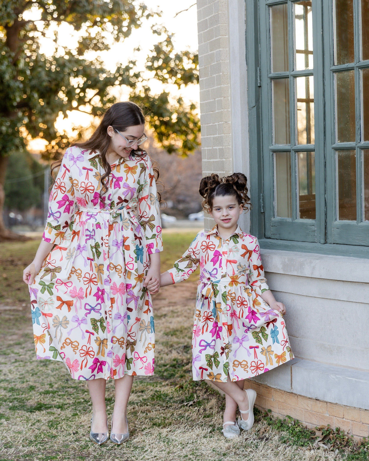 Model wearing the Nuggles® Girls' Rachel Dress in Bow Garden