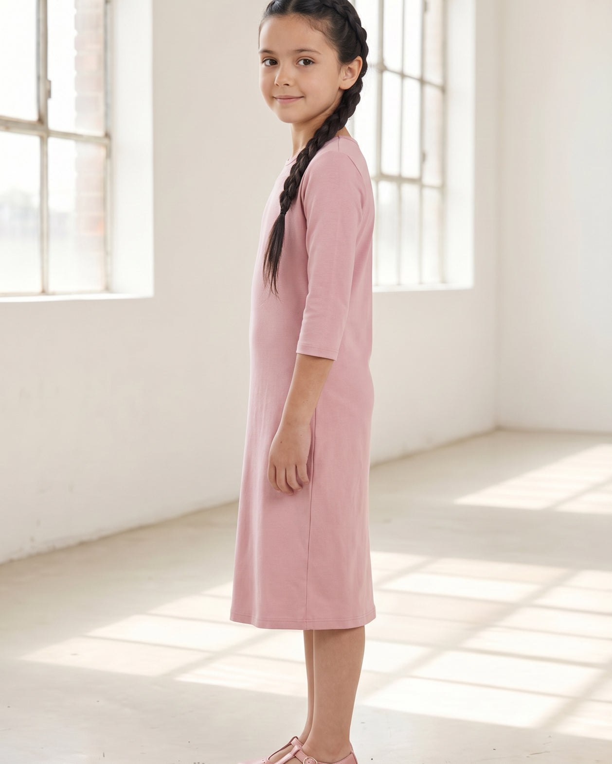 Model wearing Nuggles® Girls Layering Dress in Baby Pink