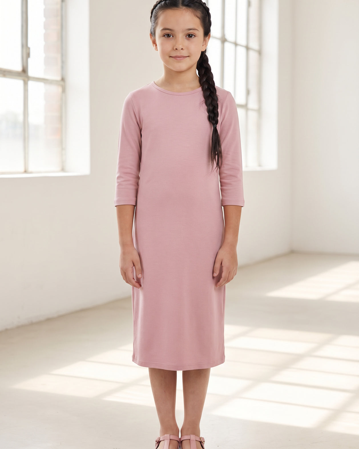 Model wearing Nuggles® Girls Layering Dress in Baby Pink