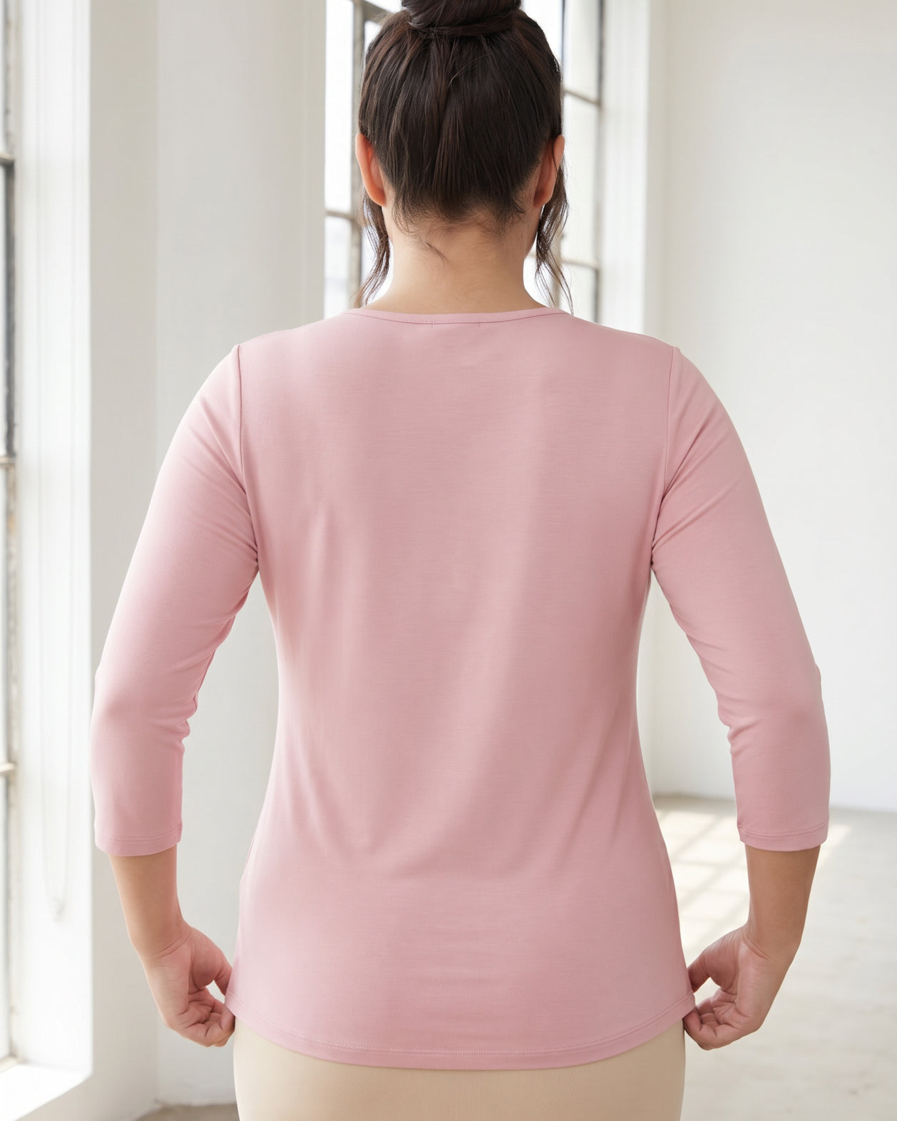 Model wearing Nuggles® 3/4 Essential Tee in Baby Pink