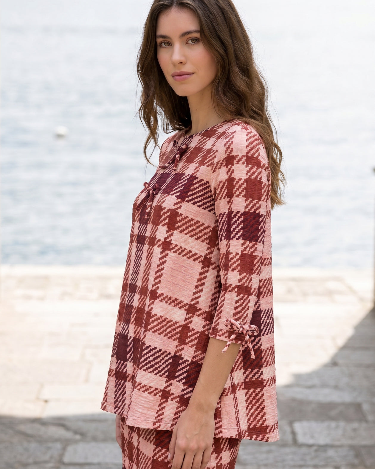 Model wearing Nuggles® Lexi Bow Top in Berry Paid