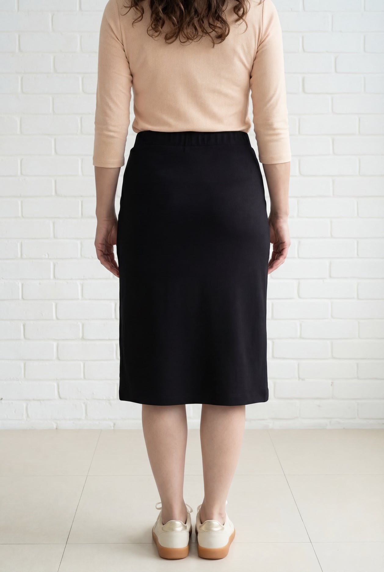 Model wearing Nuggles® 27" Relaxed Midi Skirt in Black