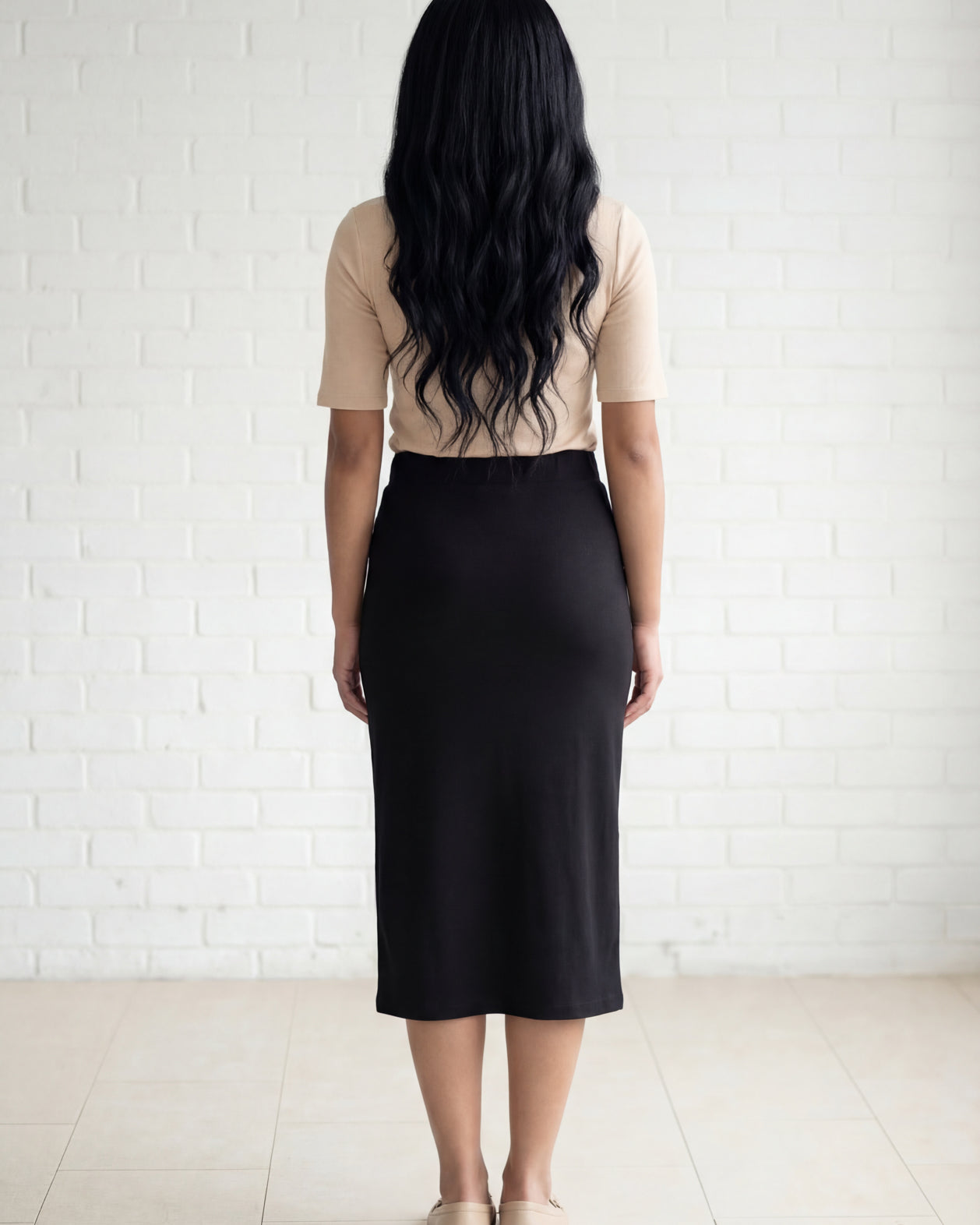 Model wearing Nuggles® 31" Relaxed Midi Skirt in Black