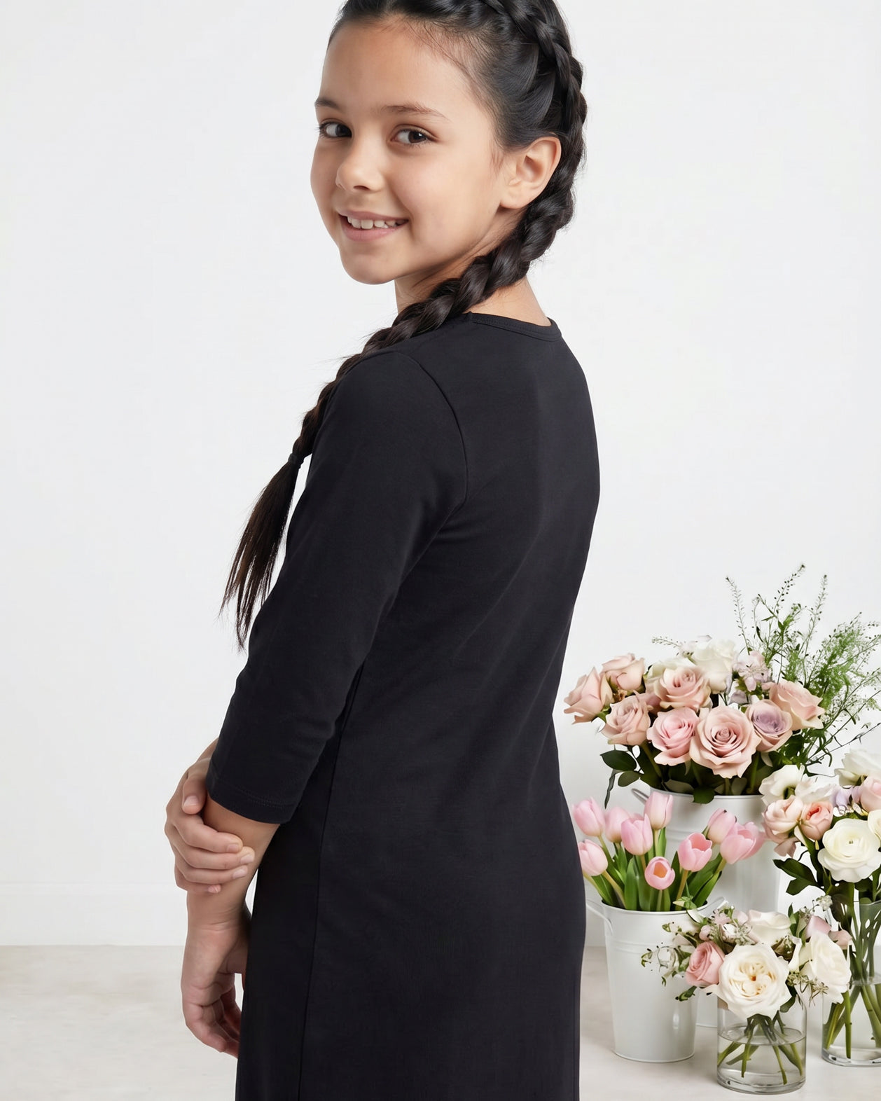 Model wearing Nuggles® Girls Midi Layering Dress in Black