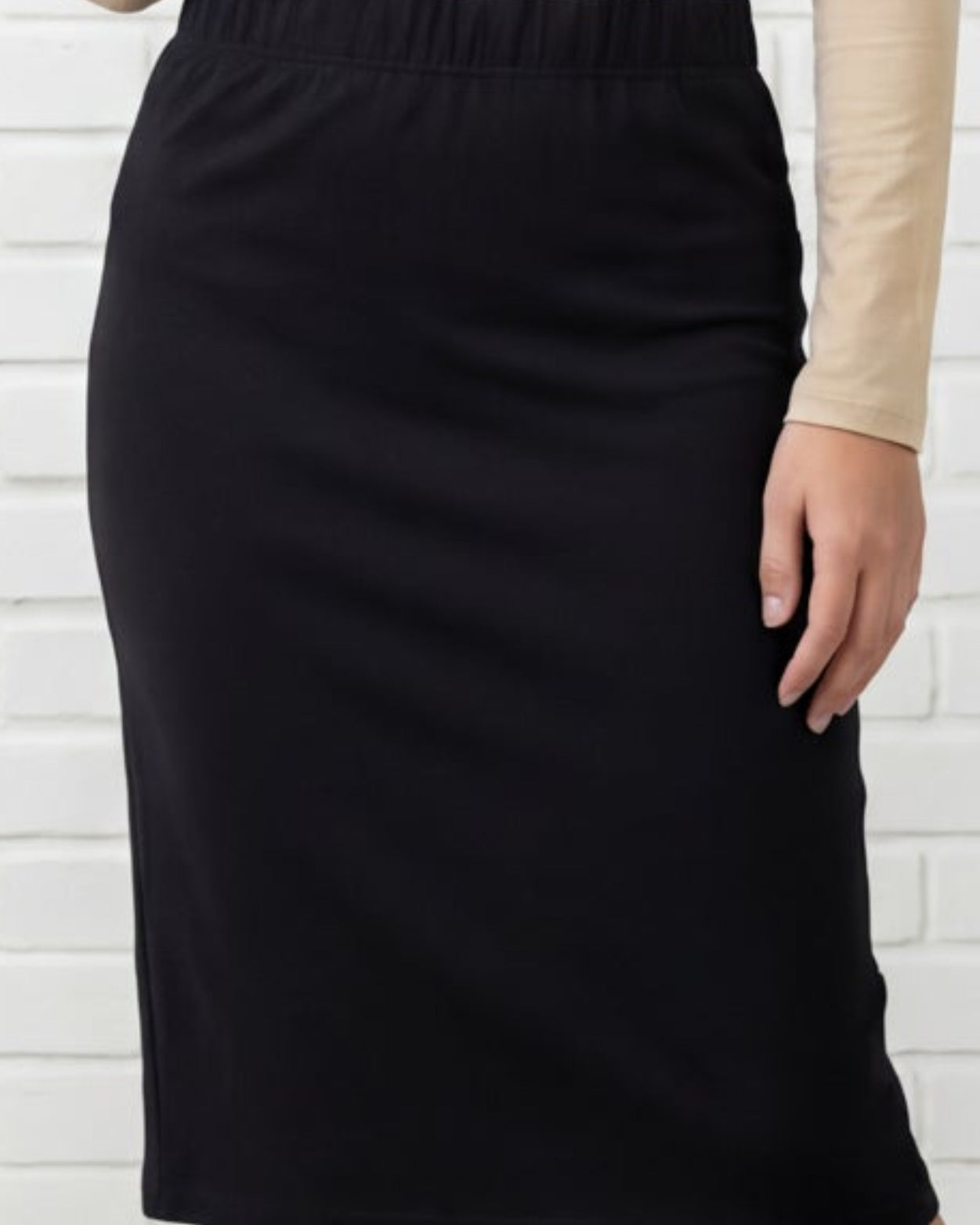 Model wearing Nuggles® Relaxed Midi Skirt in Black
