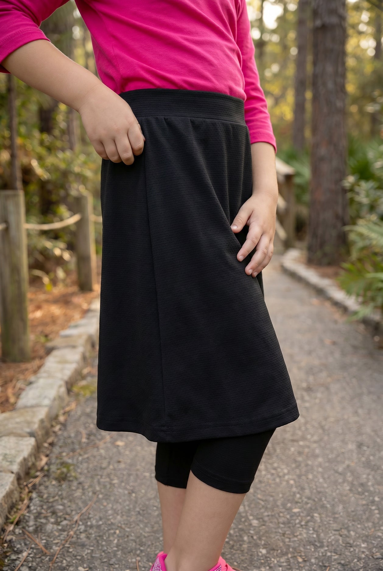 Model wearing Nuggles® Girls All-Sport Skirt in Black
