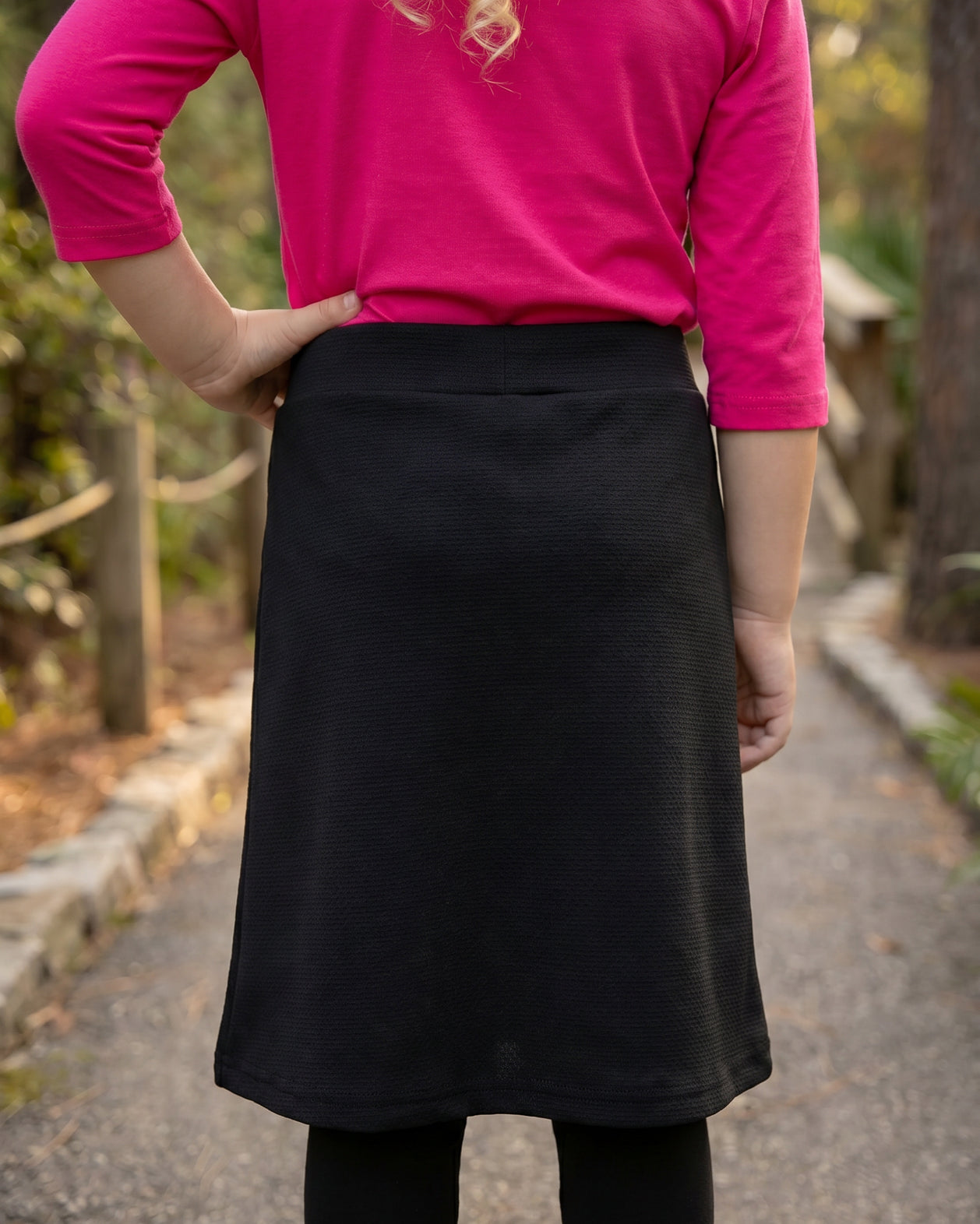 Model wearing Nuggles® Girls All-Sport Skirt in Black