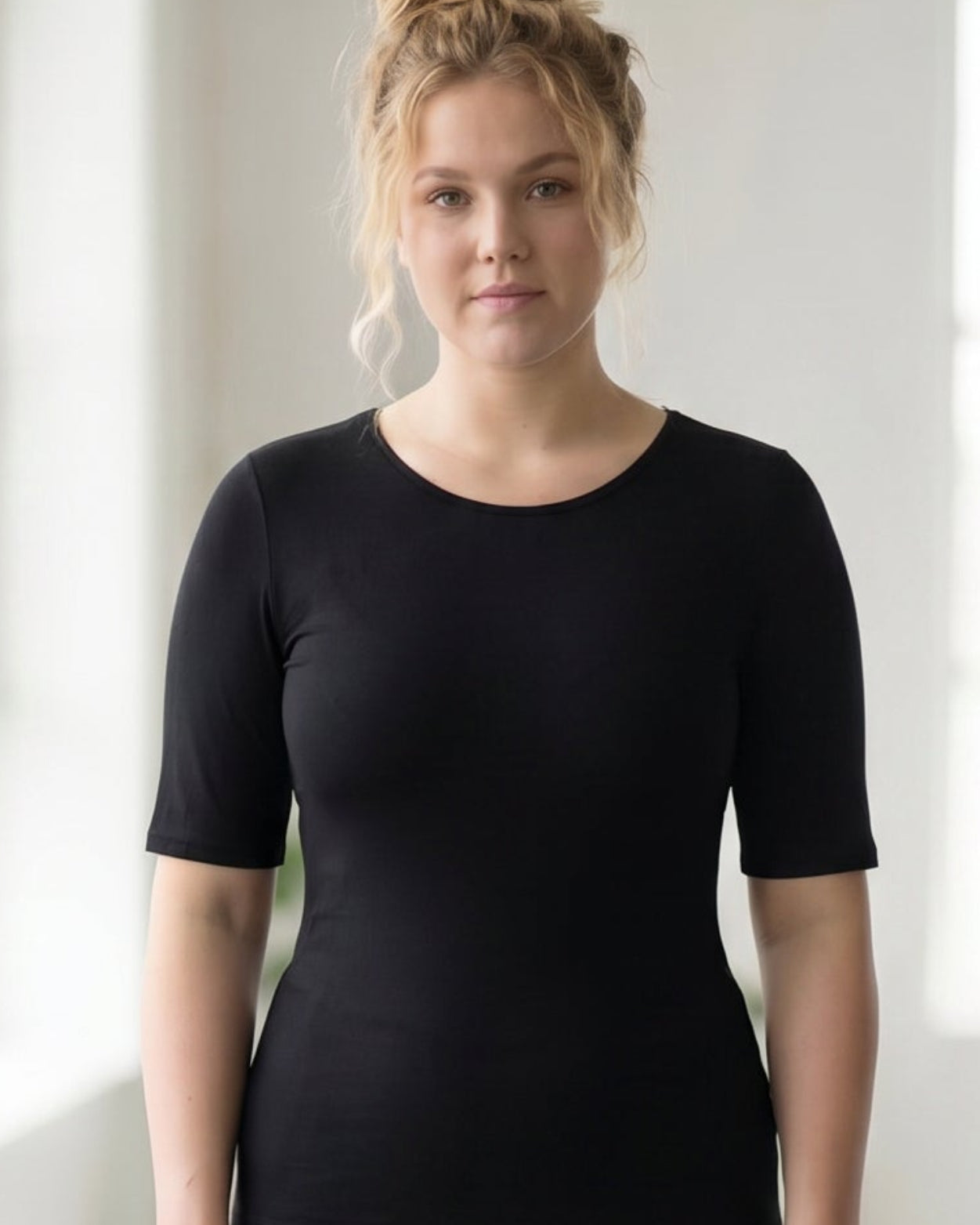 Model wearing the Nuggles® Essential Half Sleeve Tee in Black