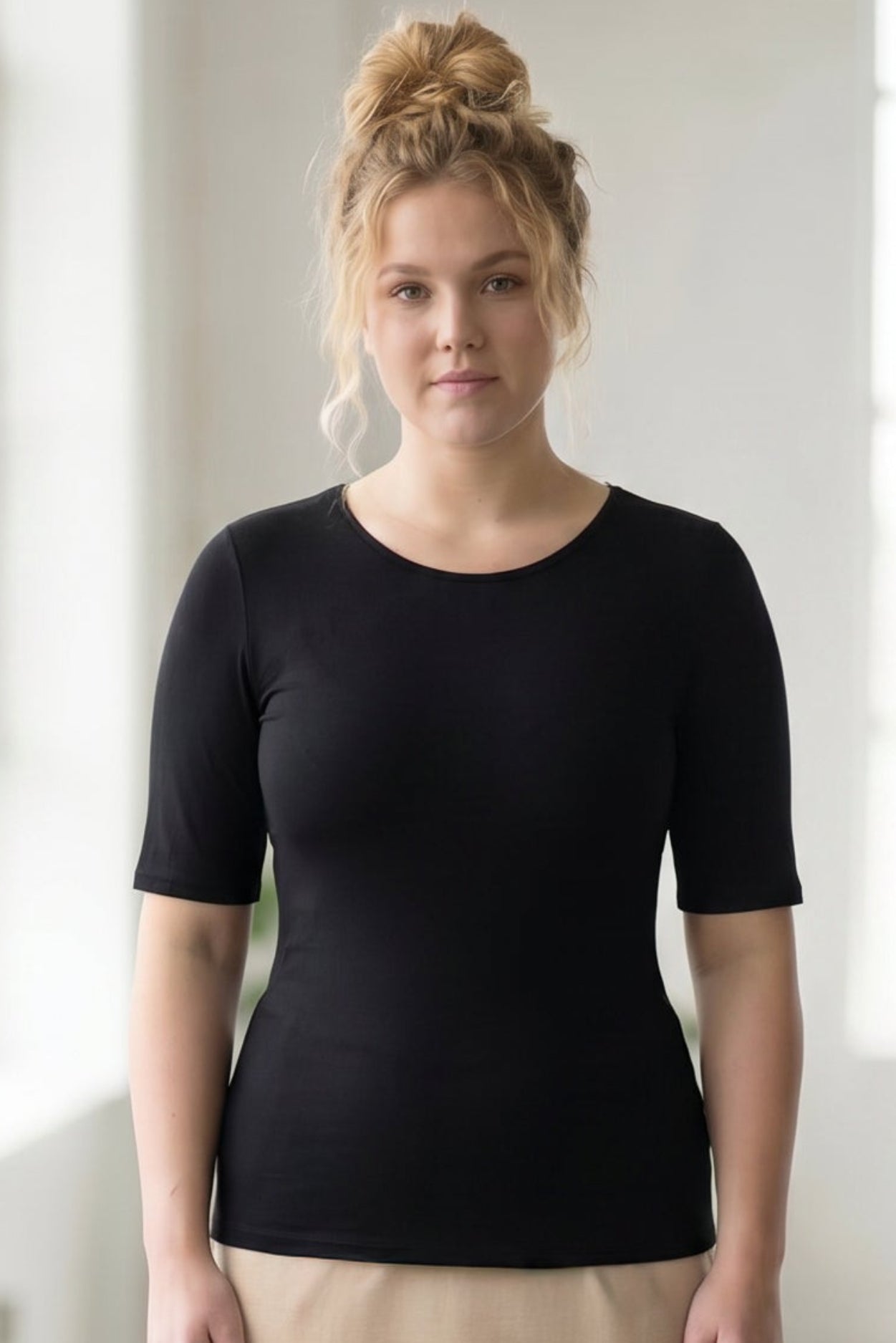 Model wearing the Nuggles® Essential Half Sleeve Tee in Black