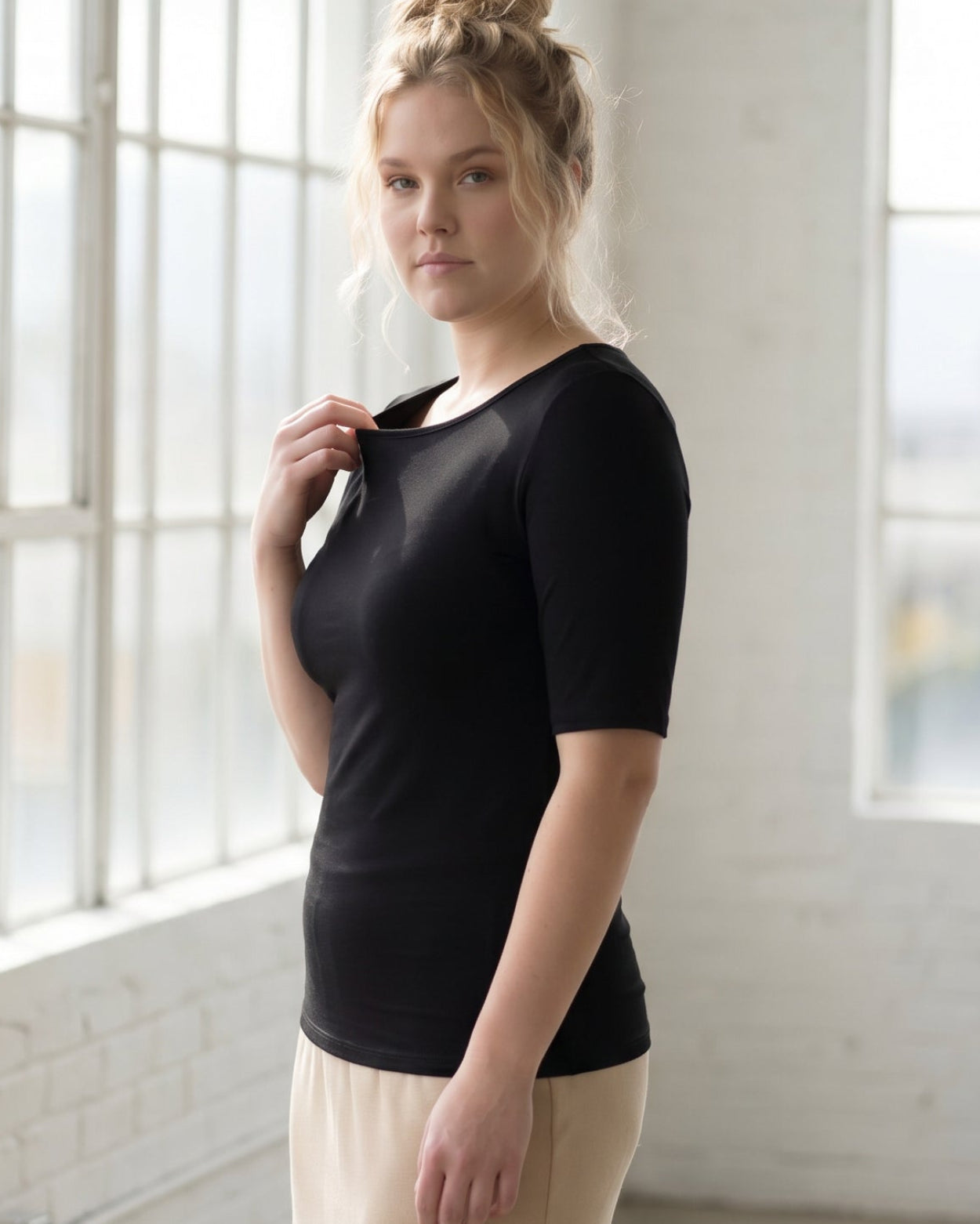 Model wearing the Nuggles® Essential Half Sleeve Tee in Black