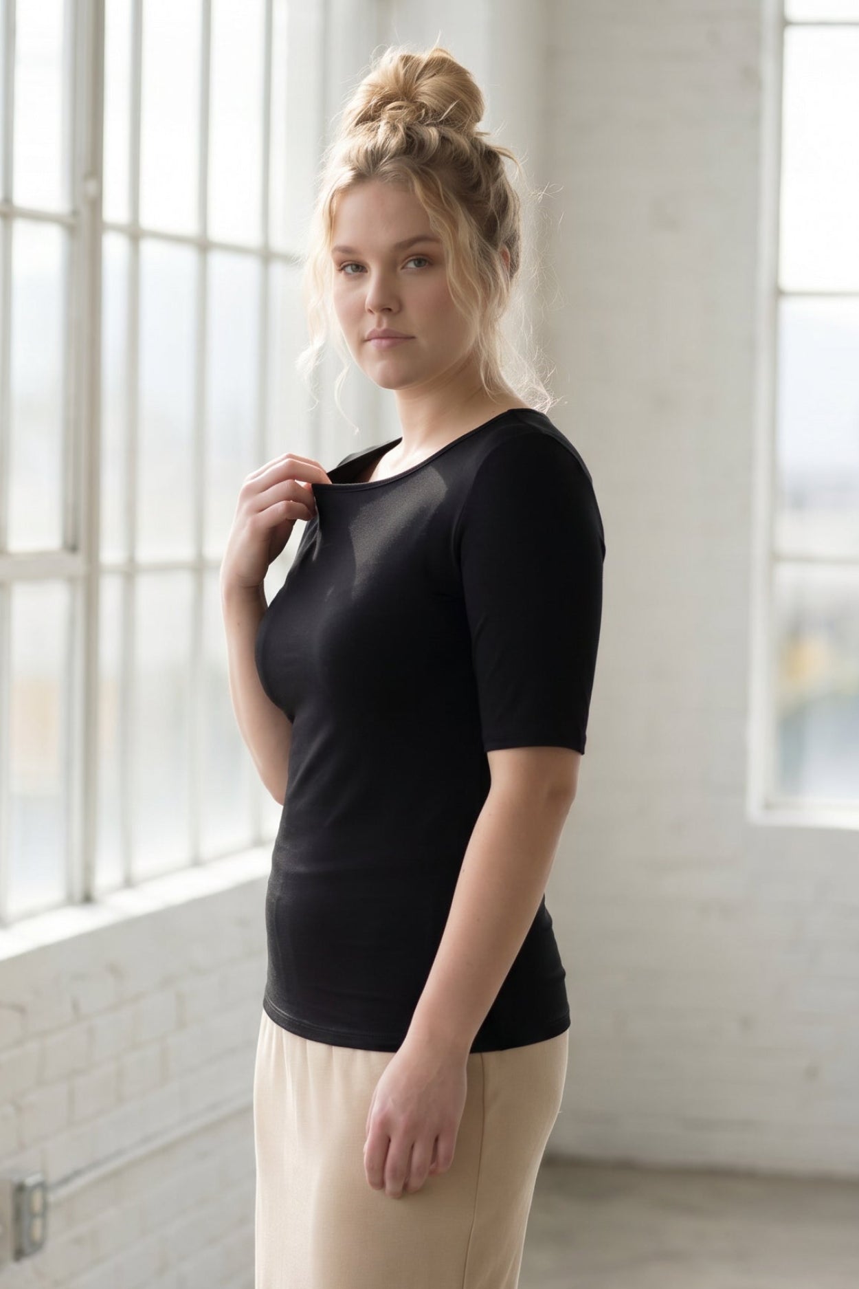 Model wearing the Nuggles® Essential Half Sleeve Tee in Black