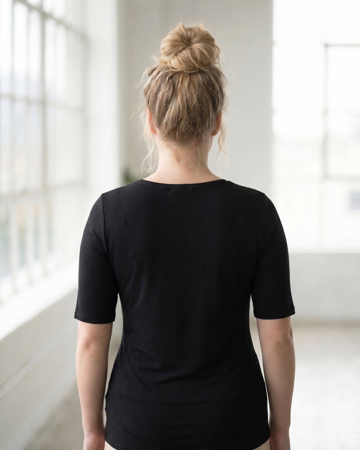 Model wearing the Nuggles® Essential Half Sleeve Tee in Black