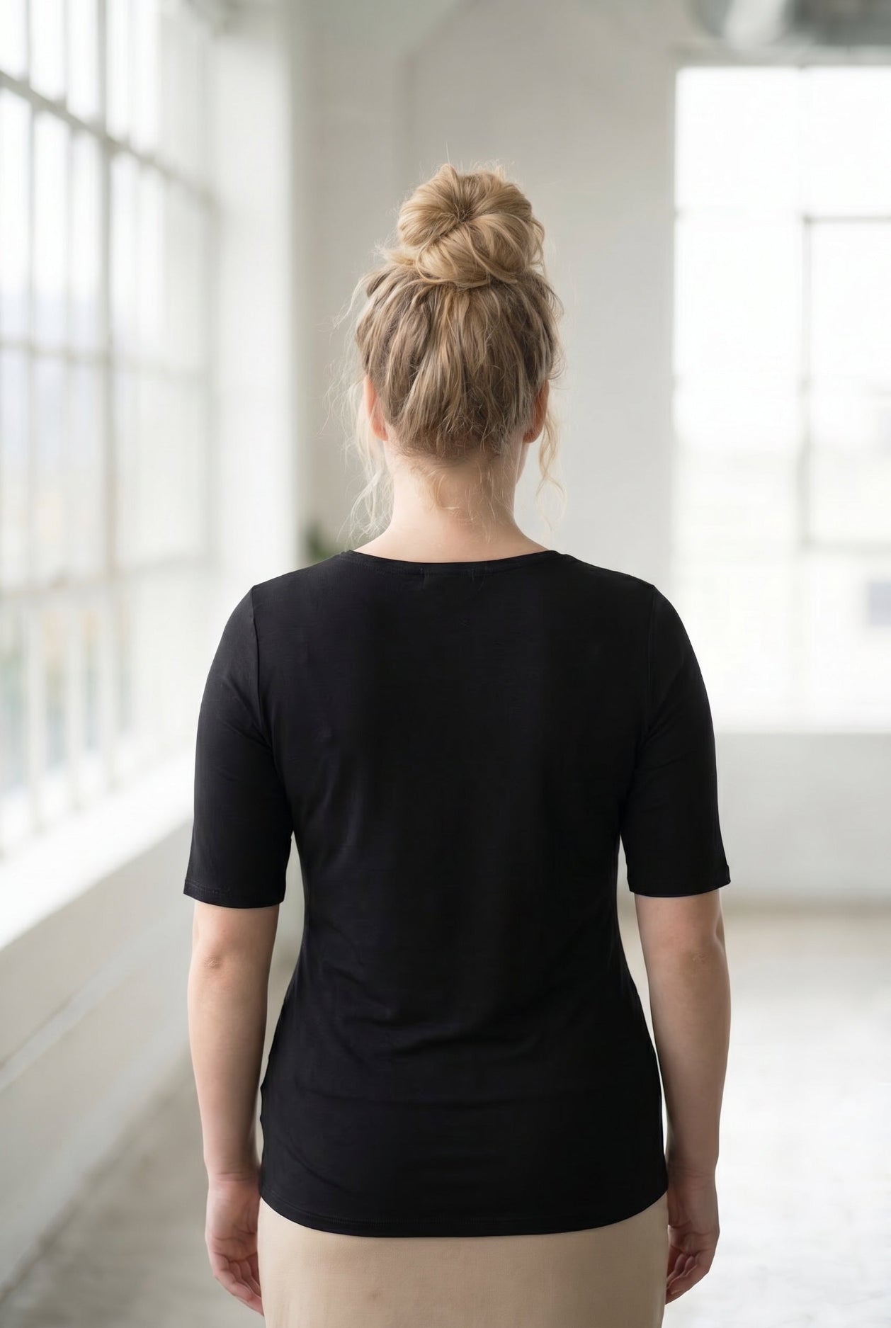 Model wearing the Nuggles® Essential Half Sleeve Tee in Black