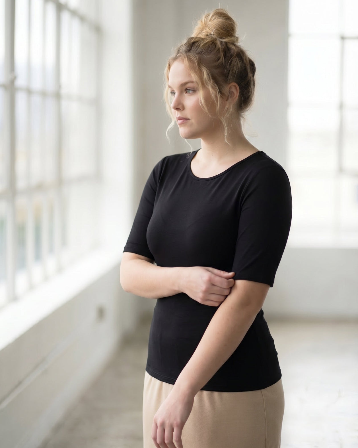 Model wearing the Nuggles® Essential Half Sleeve Tee in Black