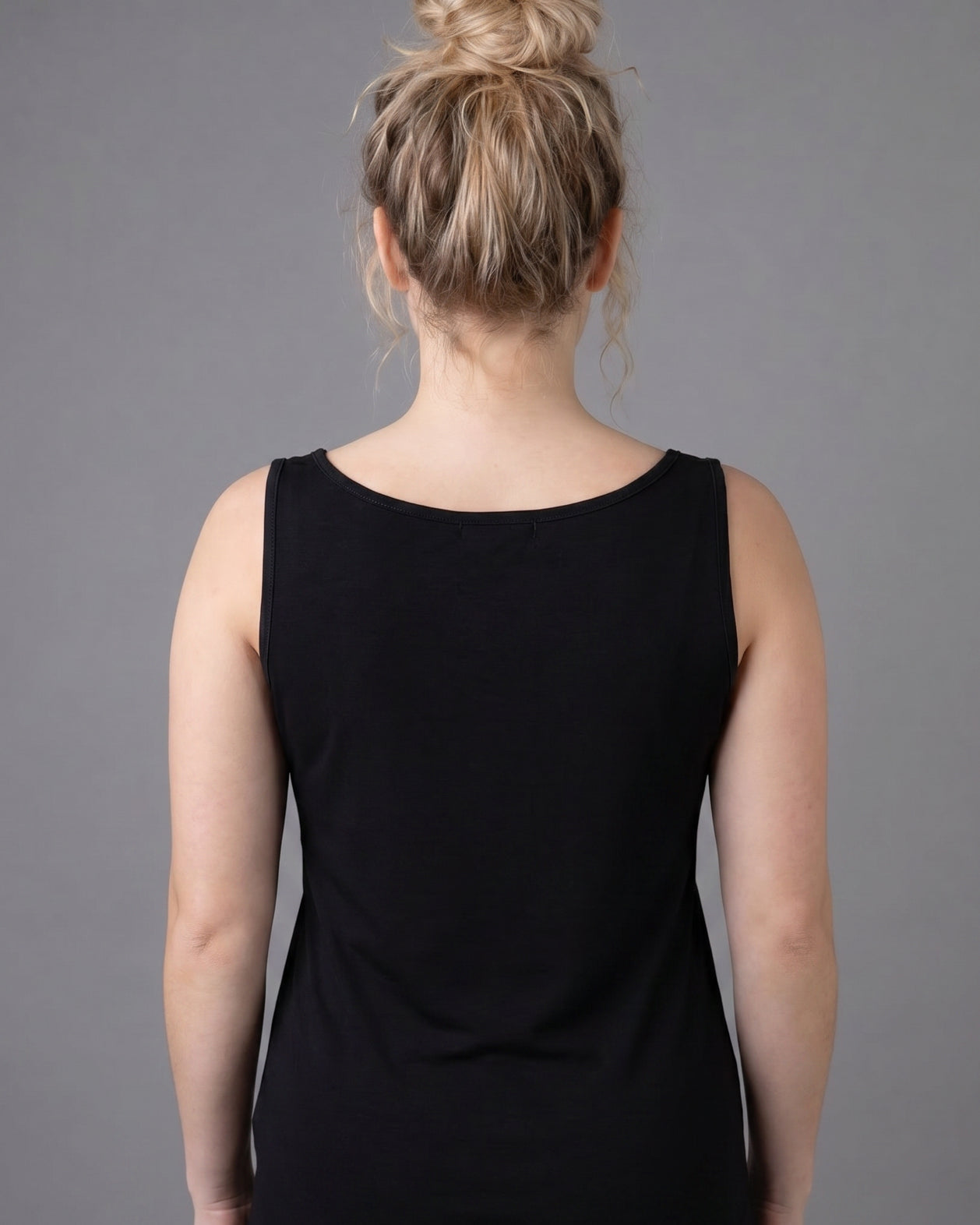 Model wearing Nuggles® Wide Neck Tank in Black