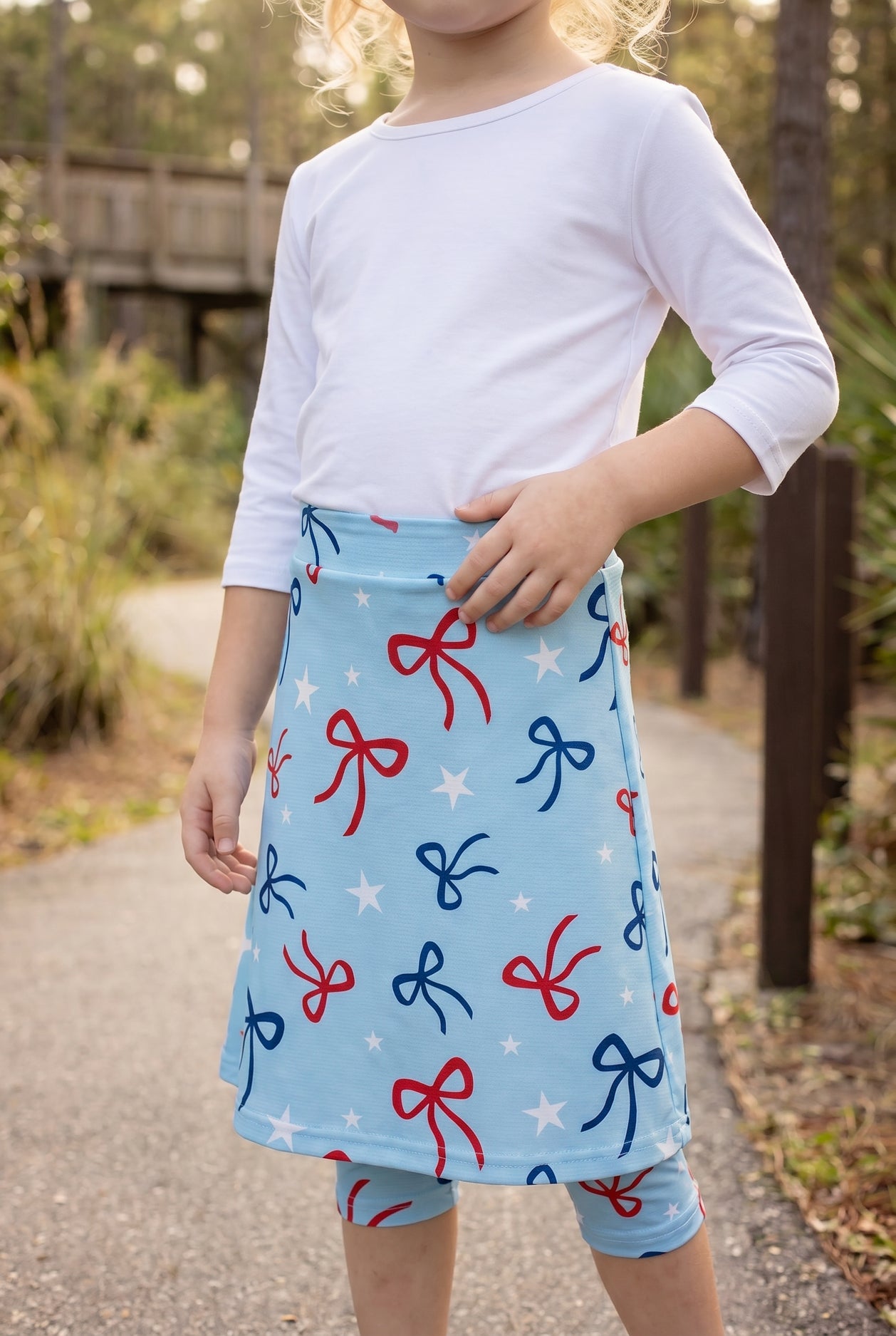 Model wearing Nuggles® Girls All-Sport Skirt in Bow Active
