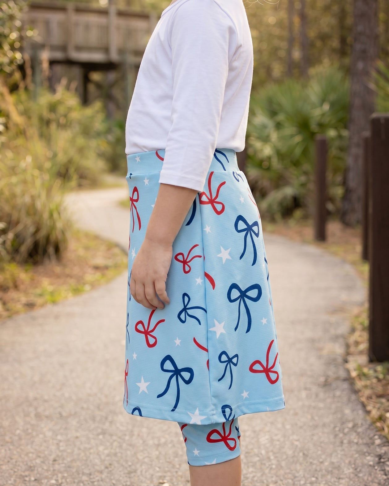 Model wearing Nuggles® Girls All-Sport Skirt in Bow Active