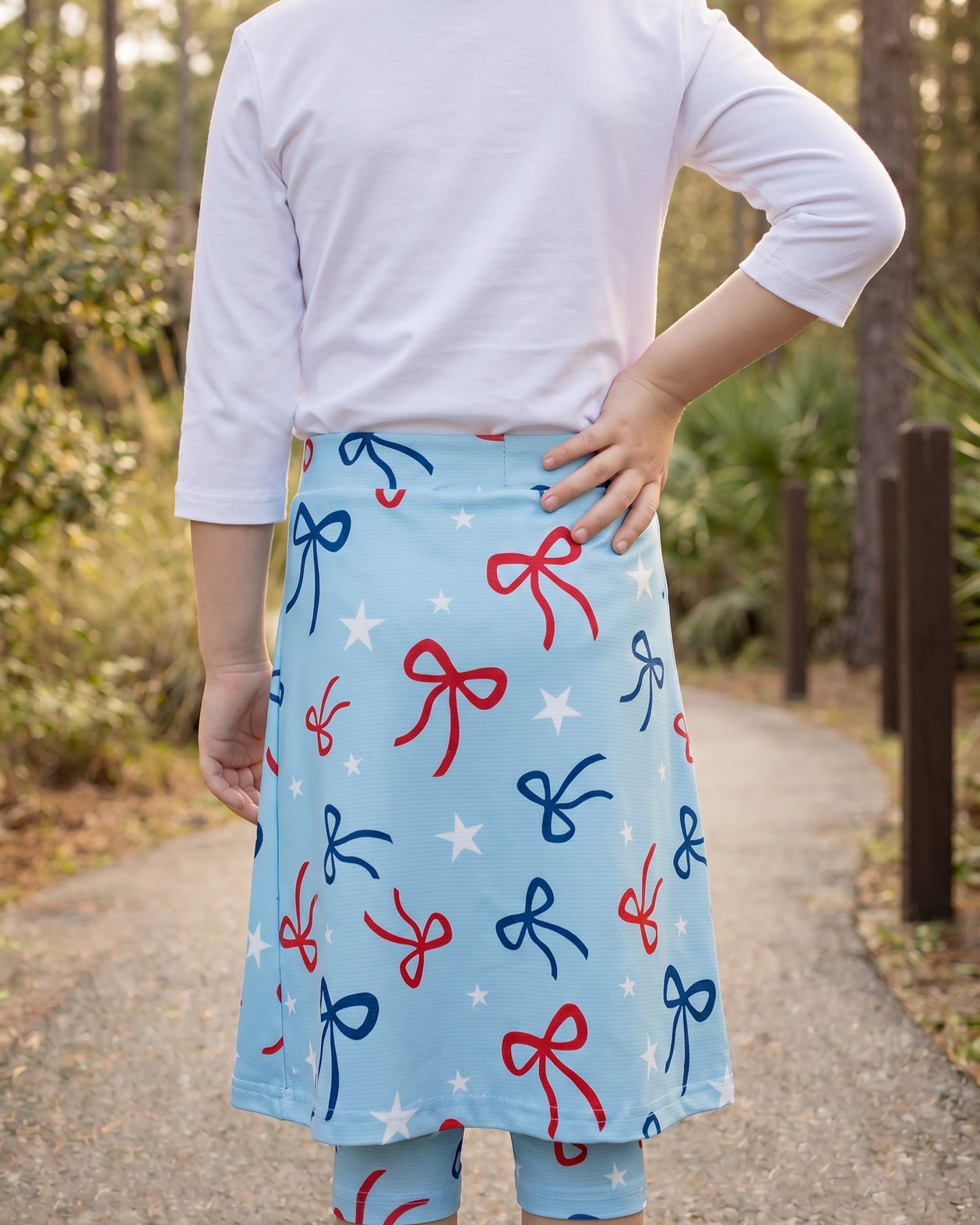 Model wearing Nuggles® Girls All-Sport Skirt in Bow Active