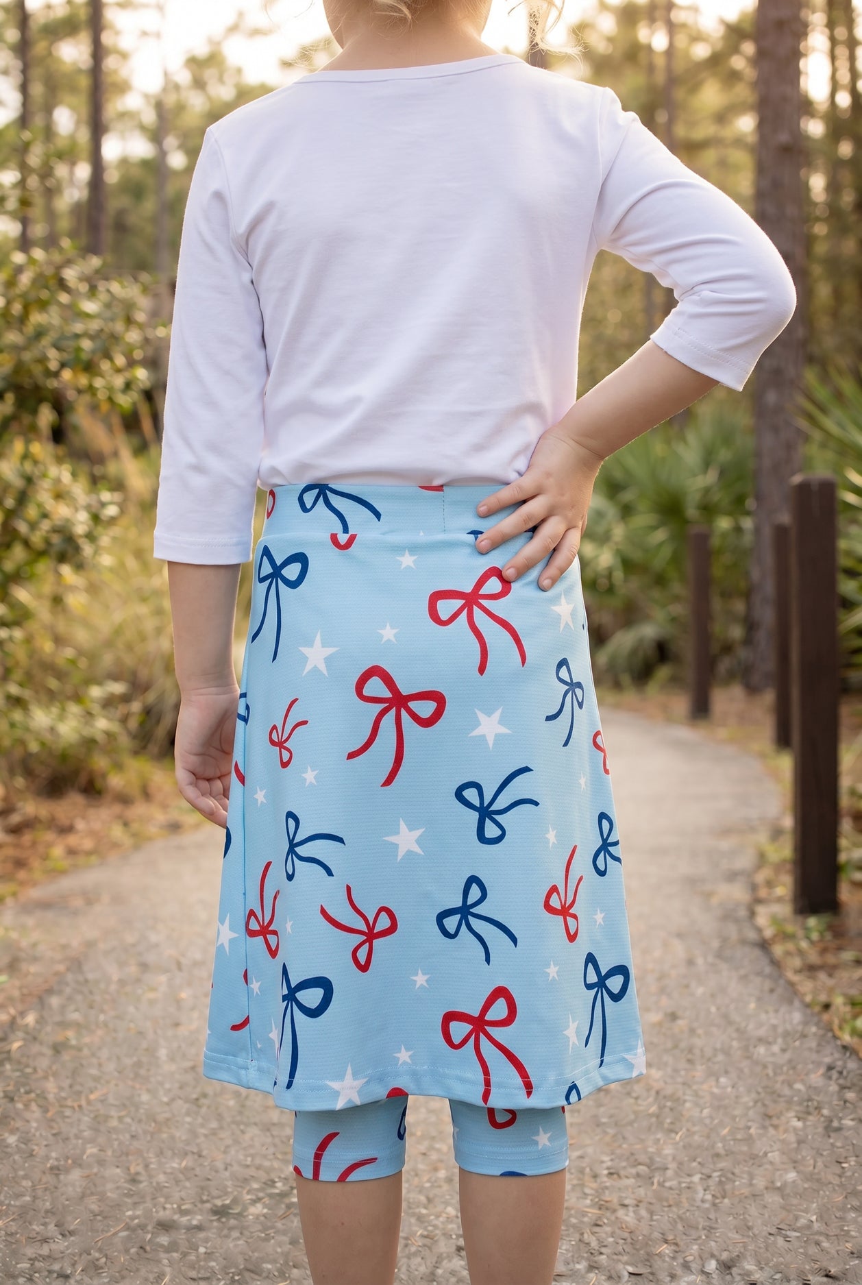 Model wearing Nuggles® Girls All-Sport Skirt in Bow Active
