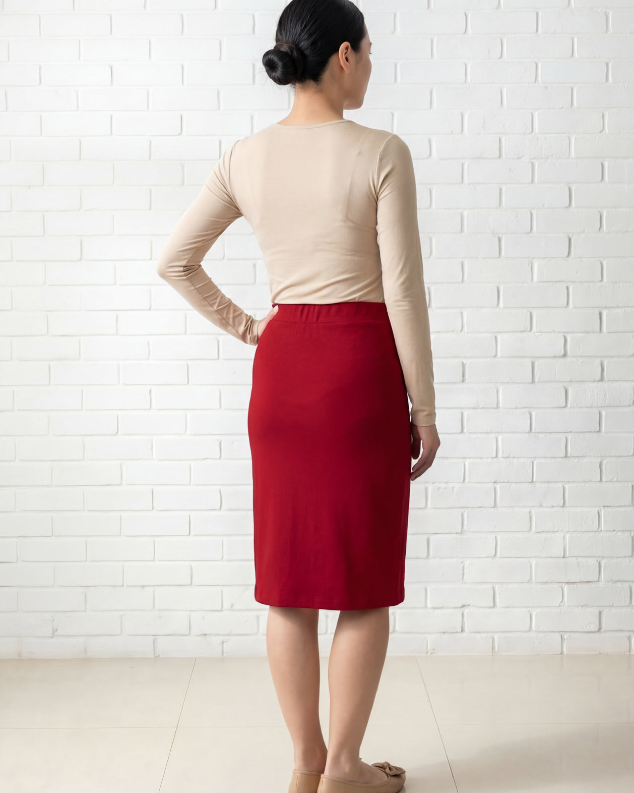 Model wearing Nuggles® 25" Relaxed Midi Skirt in Brick Red