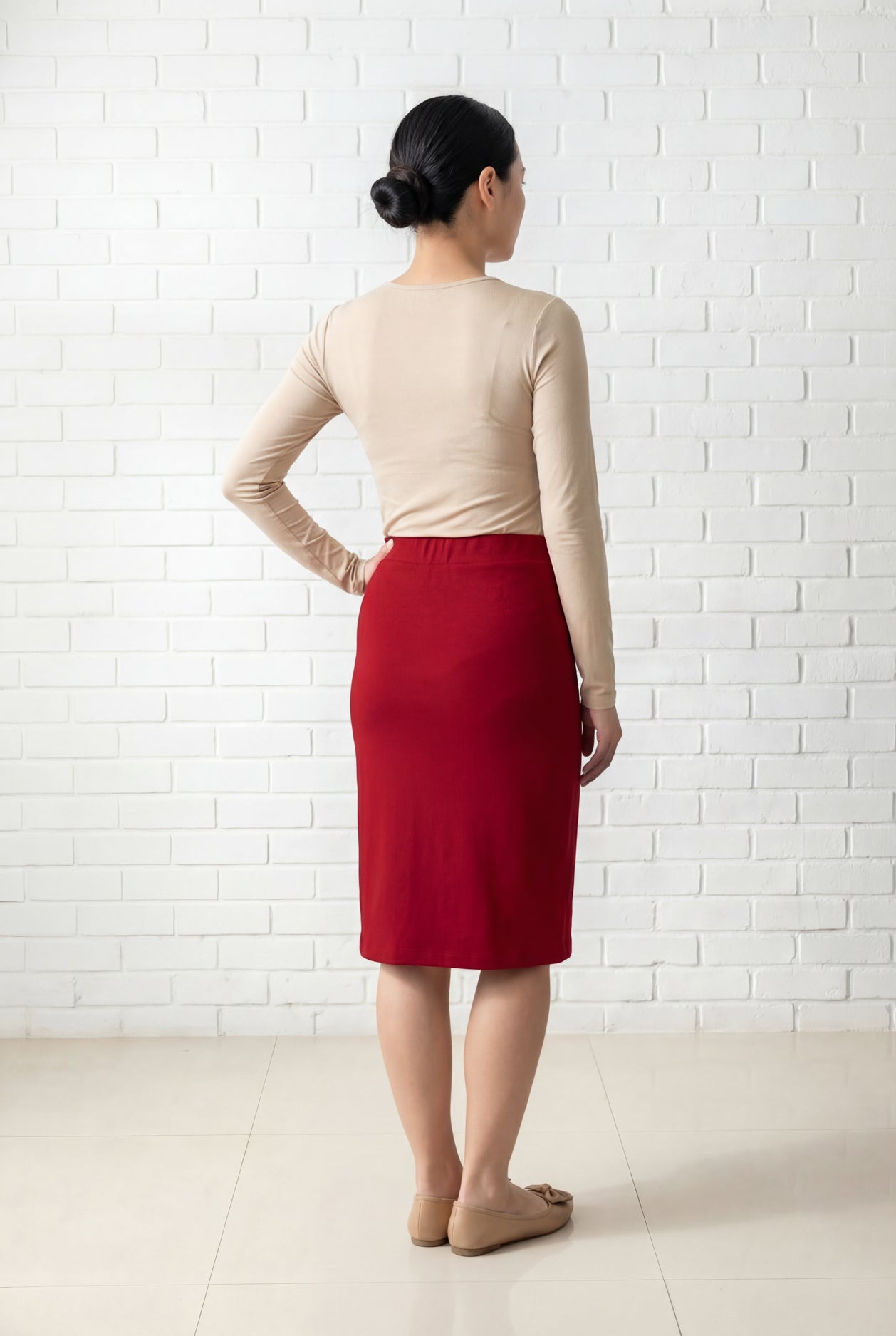 Model wearing Nuggles® 25" Relaxed Midi Skirt in Brick Red