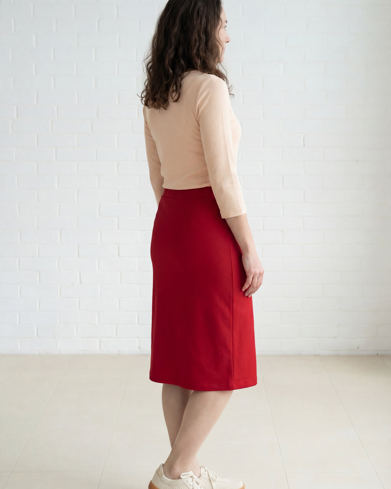 Model wearing Nuggles® 27" Relaxed Midi Skirt in Brick Red