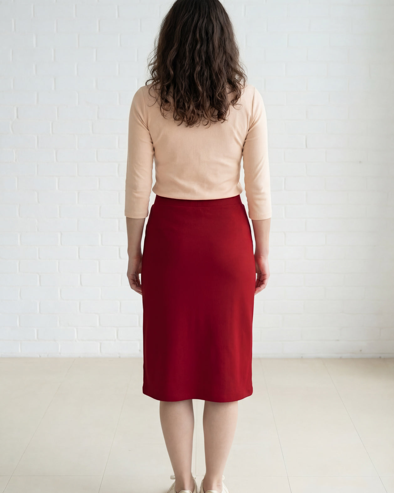 Model wearing Nuggles® 27" Relaxed Midi Skirt in Brick Red