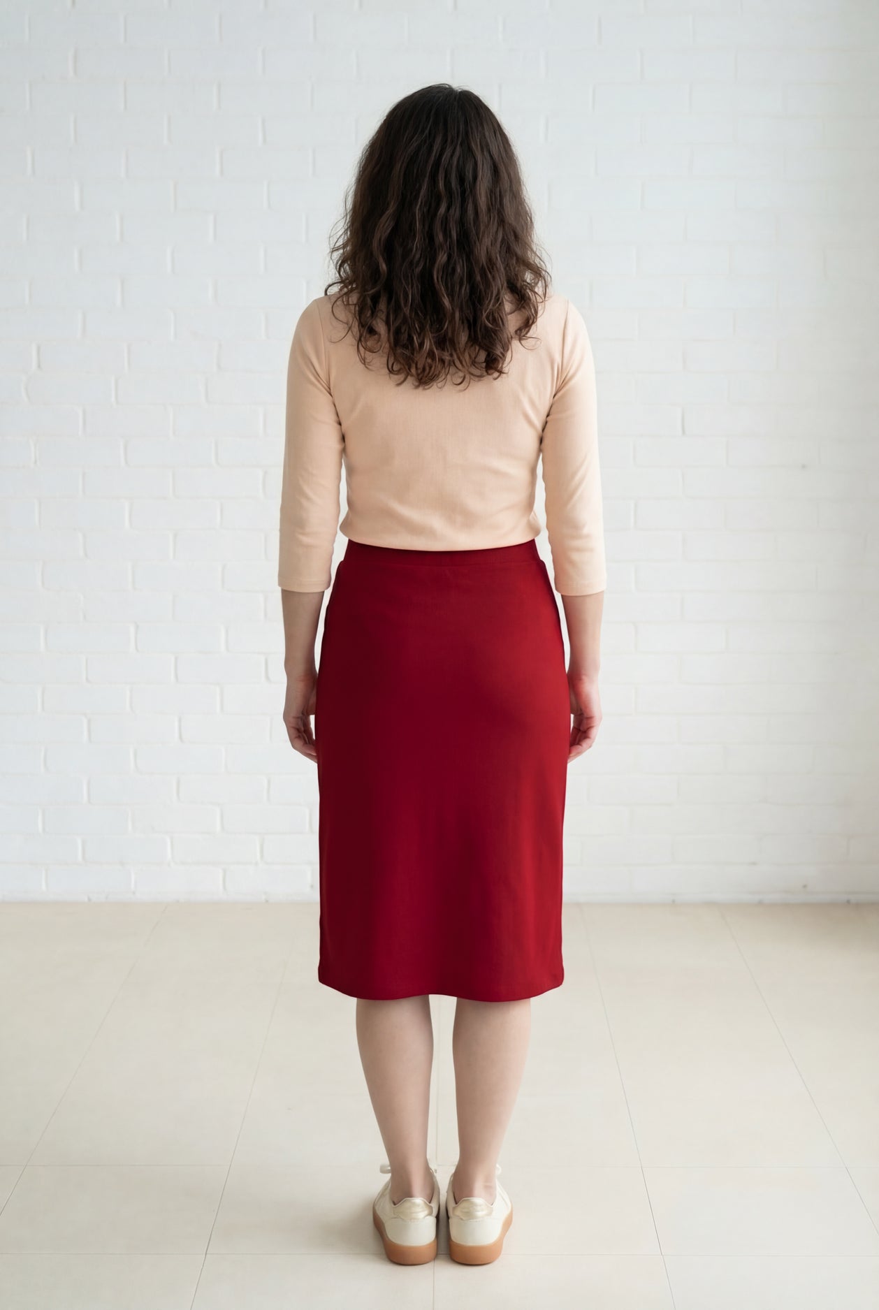Model wearing Nuggles® 27" Relaxed Midi Skirt in Brick Red