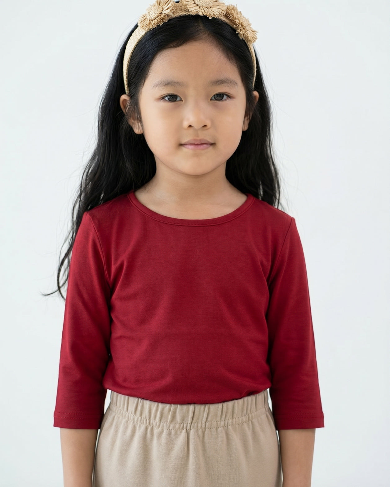 Model wearing the Girls' Nuggles® Essential 3/4 Tee in Brick Red