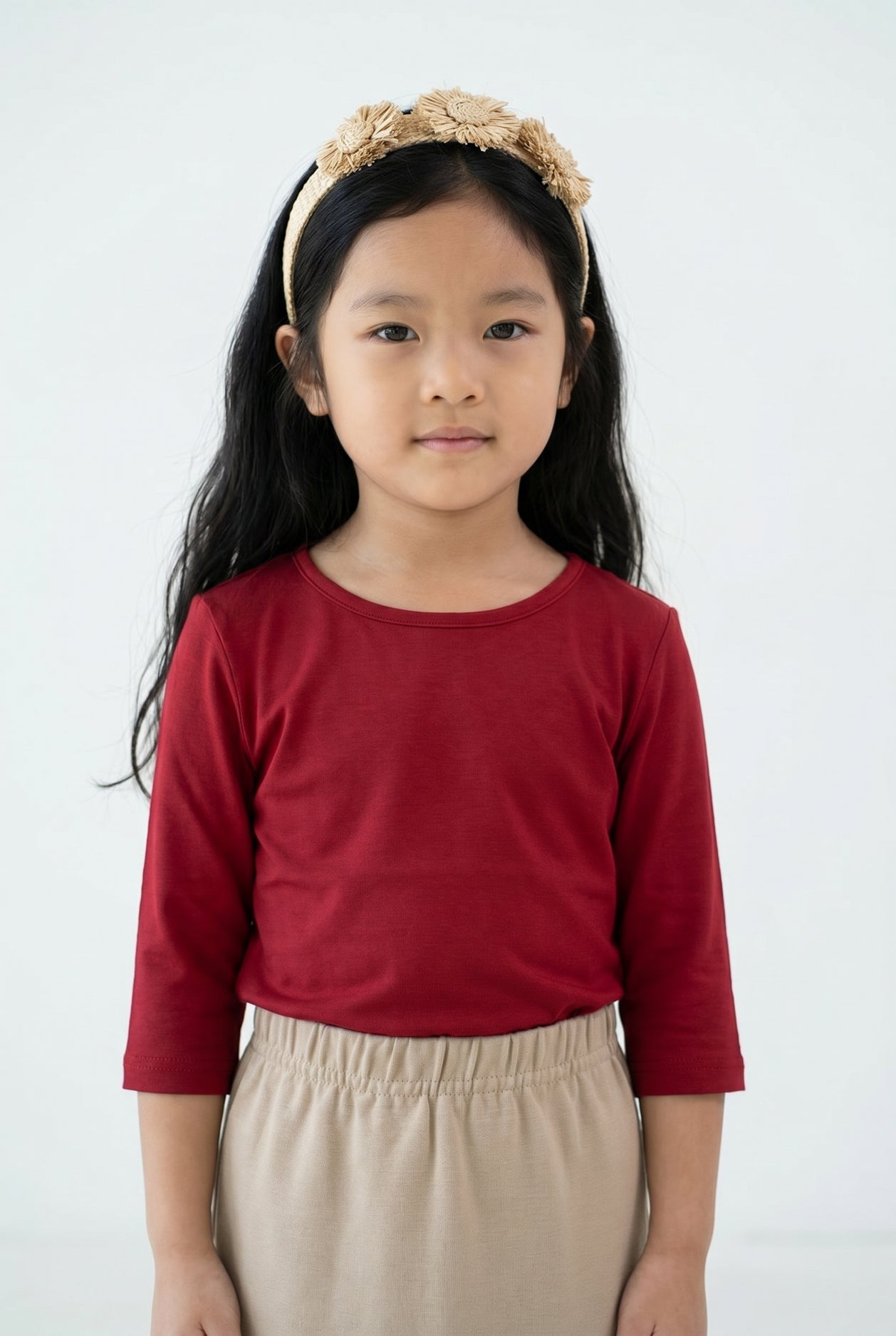 Model wearing the Girls' Nuggles® Essential 3/4 Tee in Brick Red
