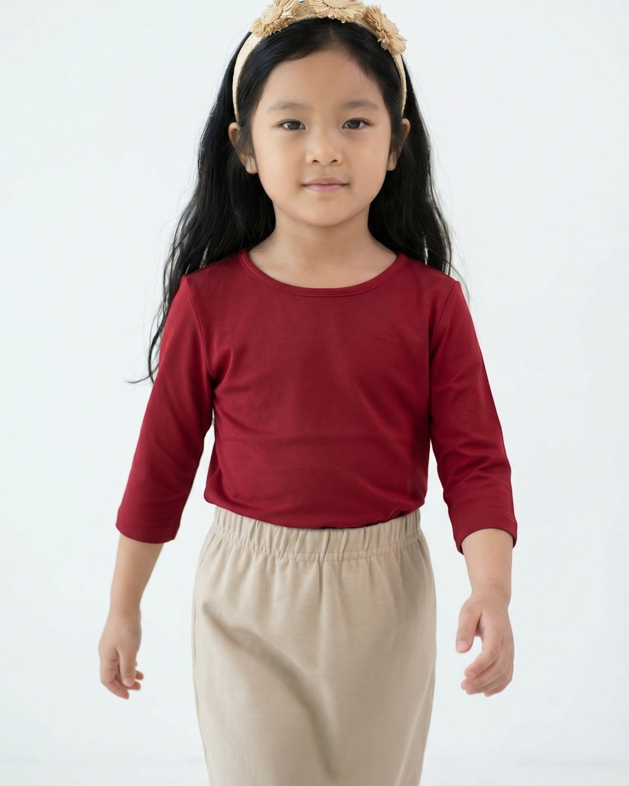 Model wearing the Girls' Nuggles® Essential 3/4 Tee in Brick Red