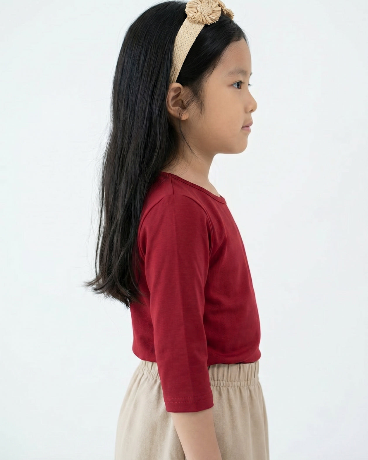 Model wearing the Girls' Nuggles® Essential 3/4 Tee in Brick Red