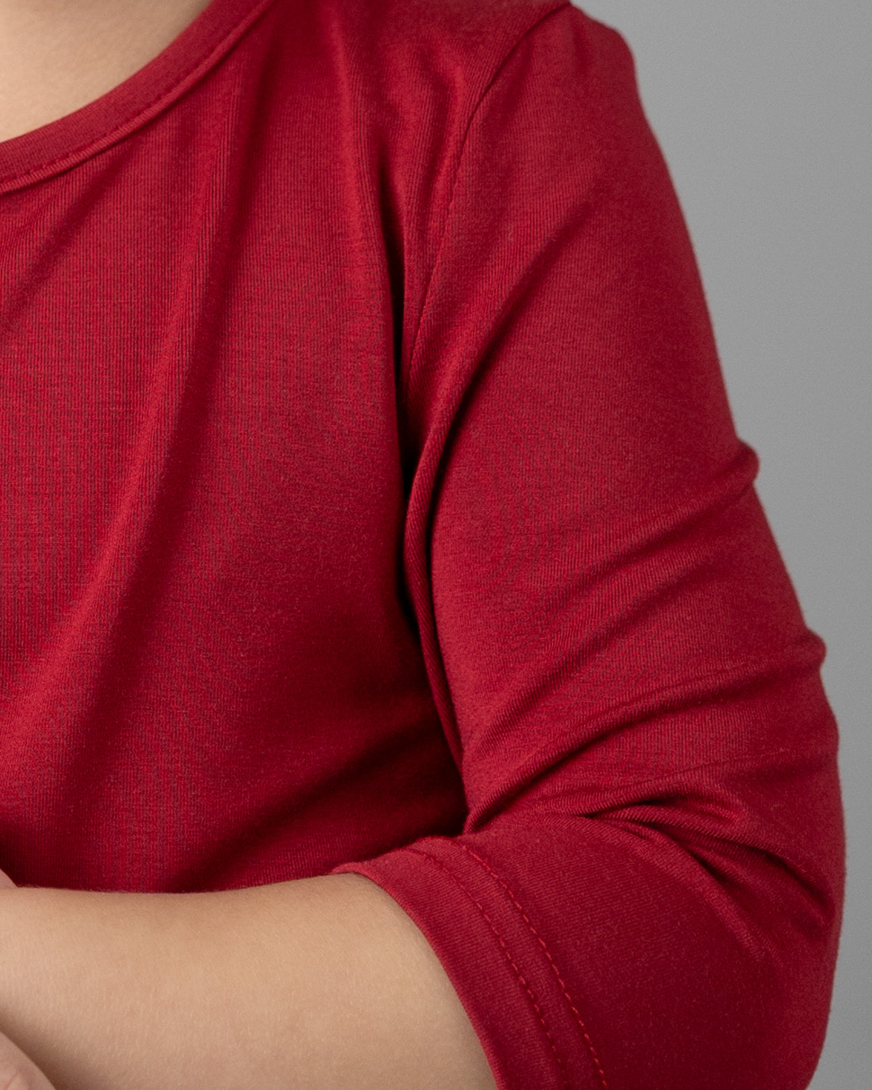 Model wearing the Girls' Nuggles® Essential 3/4 Tee in Brick Red