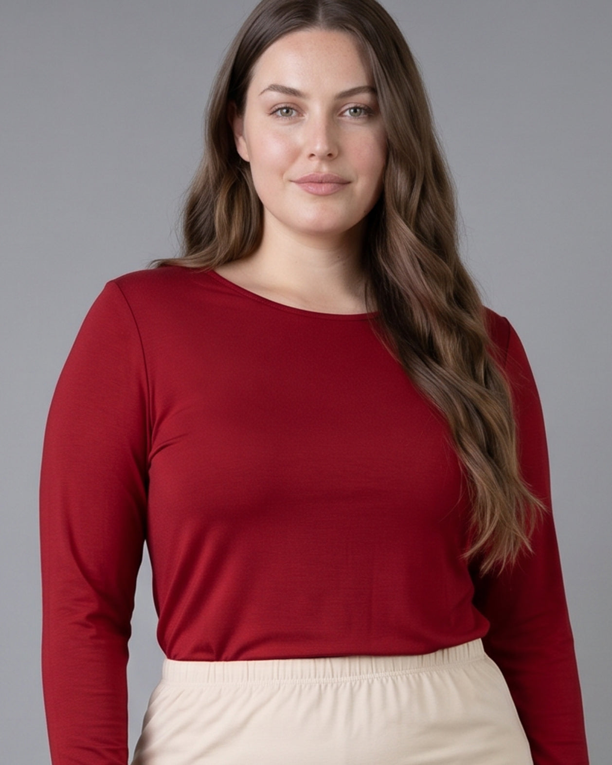 Model wearing Nuggles® Long Sleeve Essential Tee in Brick Red