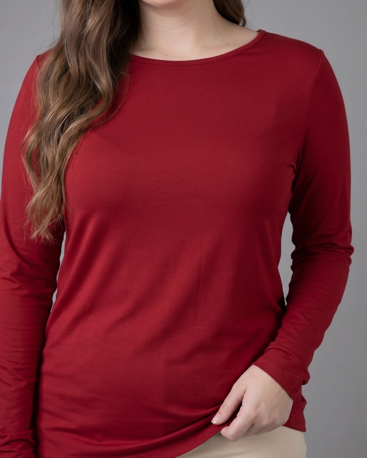 Model wearing Nuggles® Long Sleeve Essential Tee in Brick Red