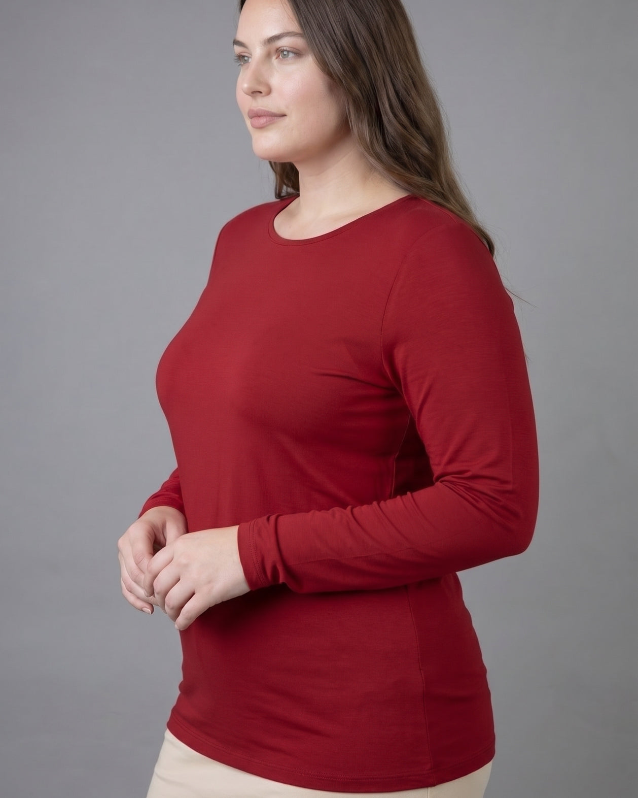 Model wearing Nuggles® Long Sleeve Essential Tee in Brick Red