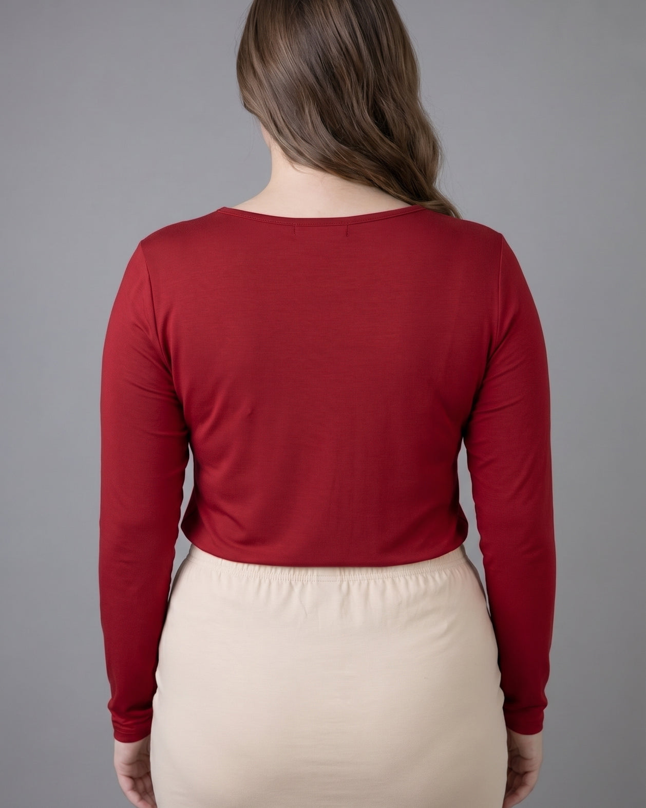 Model wearing Nuggles® Long Sleeve Essential Tee in Brick Red