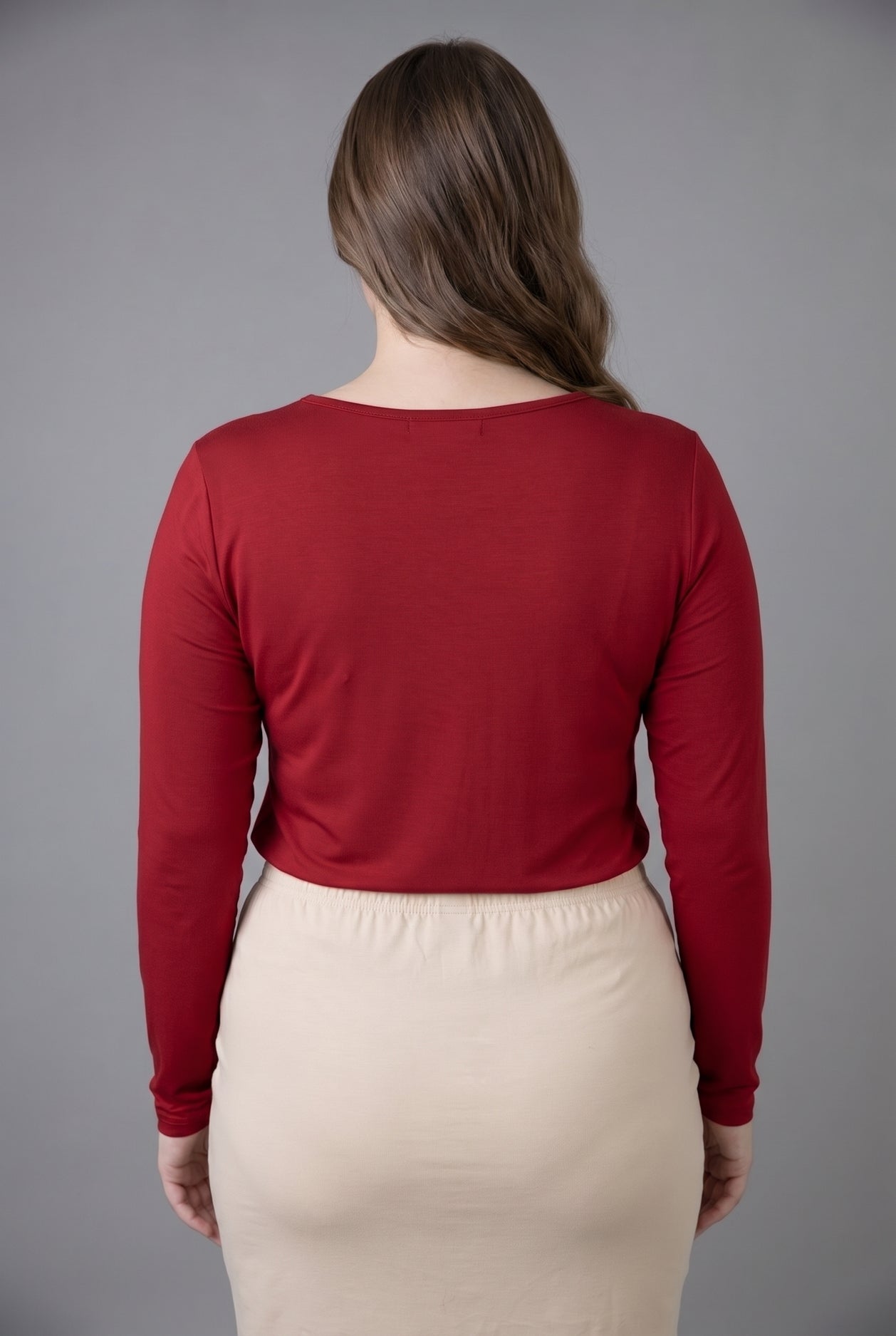 Model wearing Nuggles® Long Sleeve Essential Tee in Brick Red