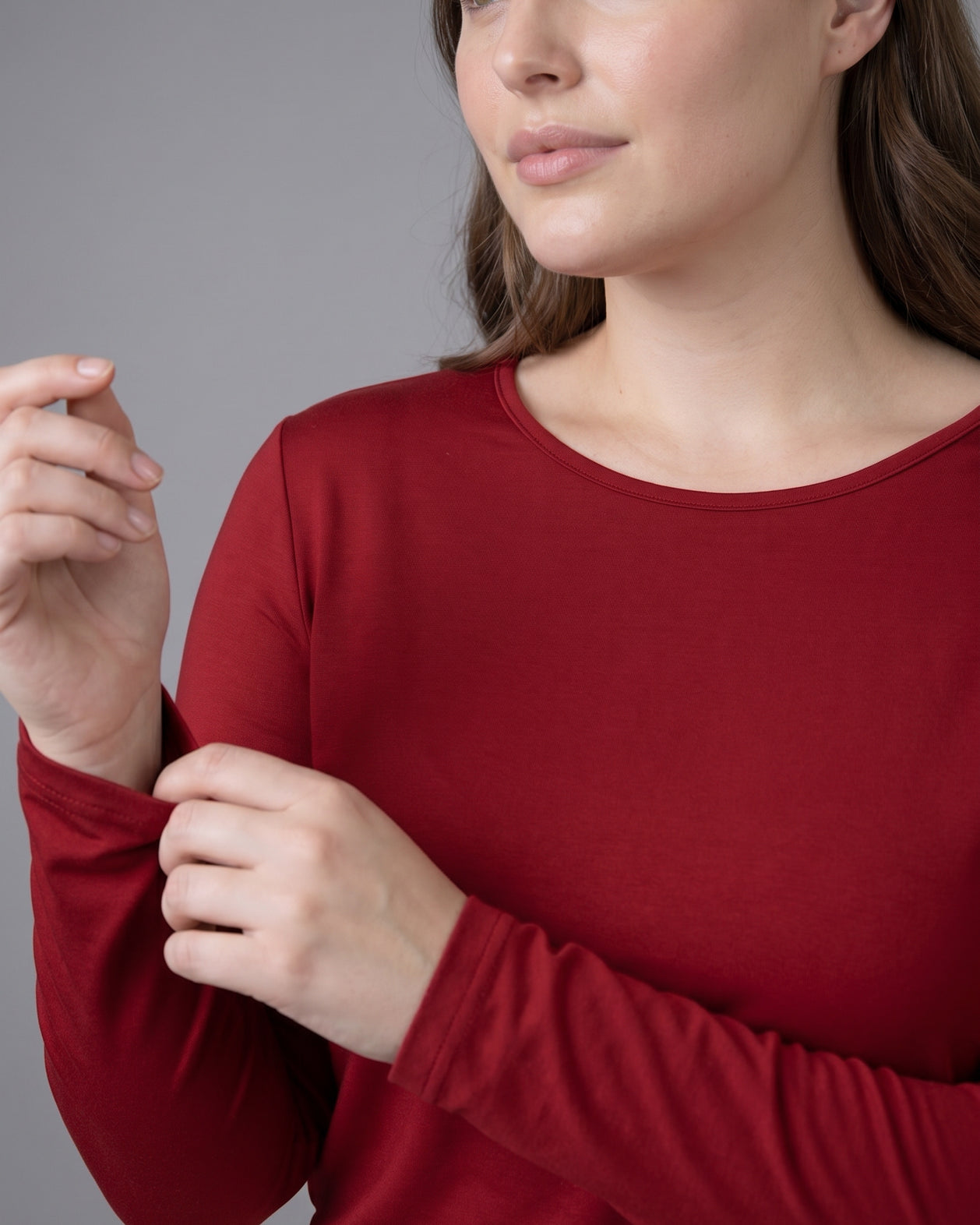 Model wearing Nuggles® Long Sleeve Essential Tee in Brick Red