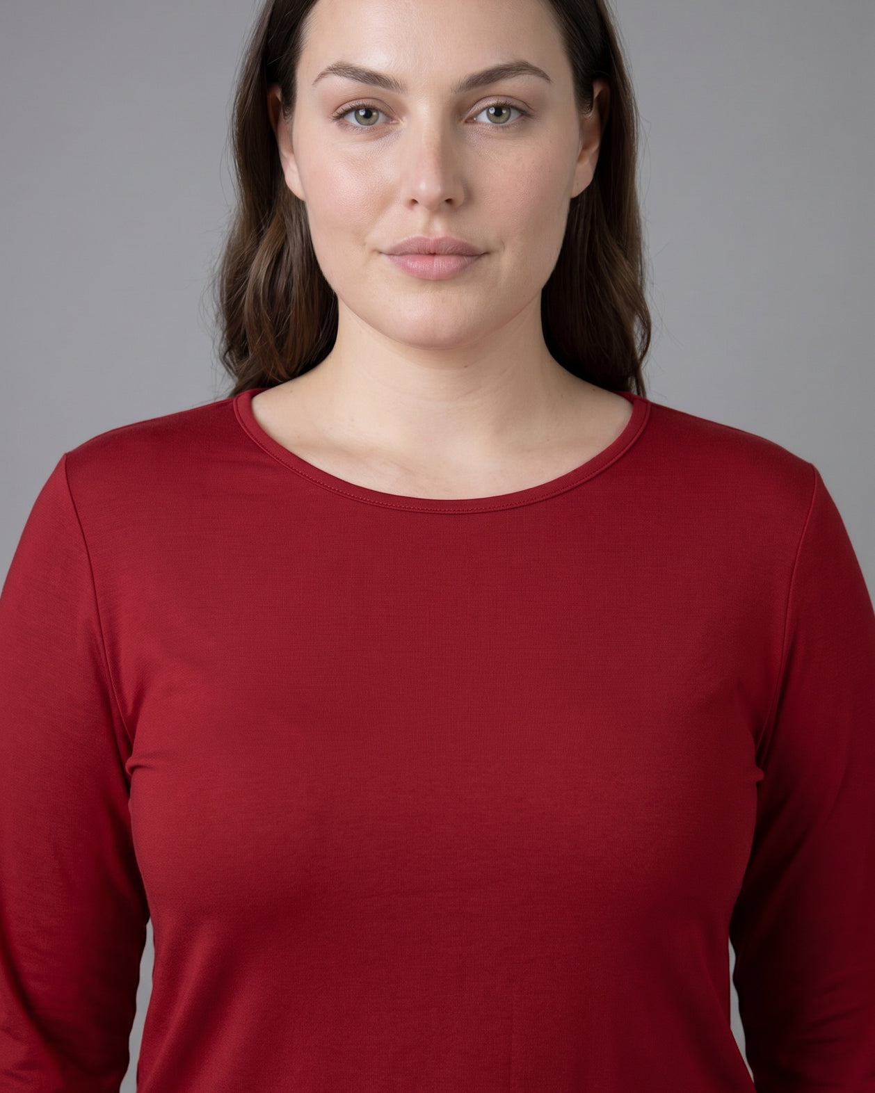 Model wearing Nuggles® Long Sleeve Essential Tee in Brick Red