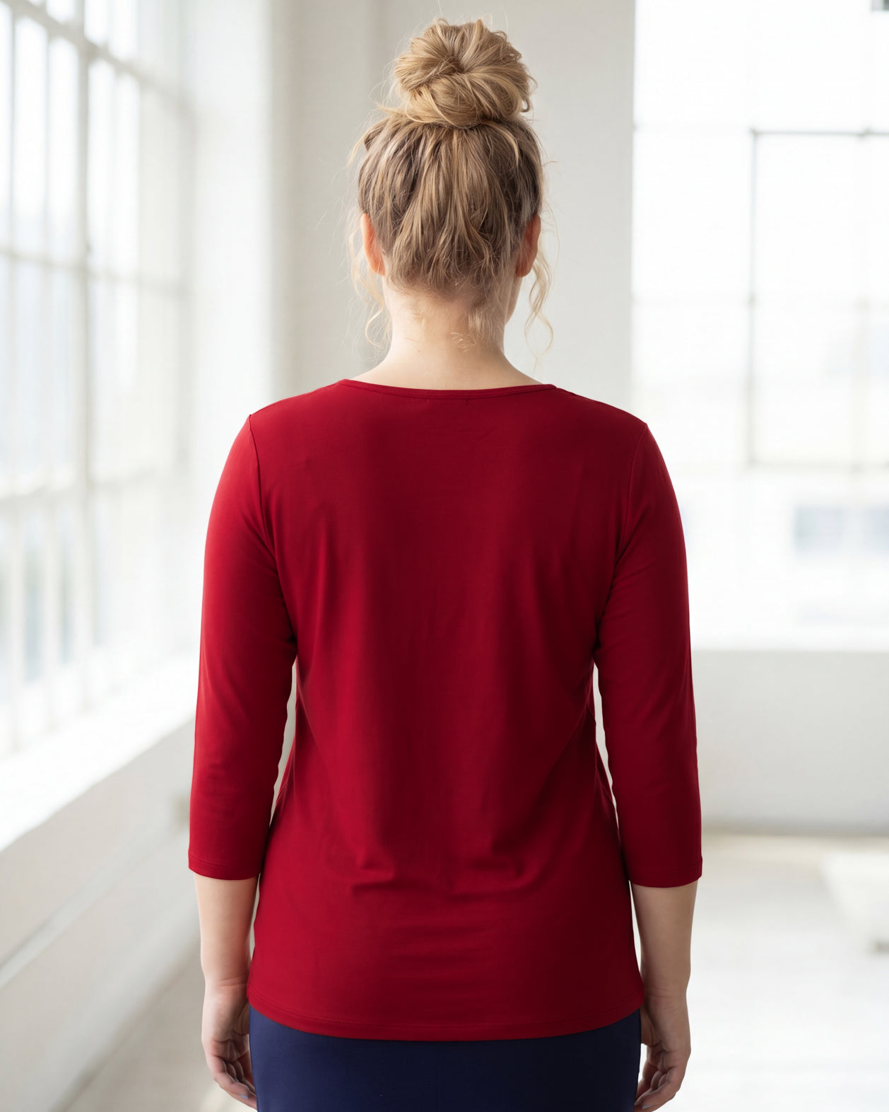 Model wearing Nuggles® 3/4 Essential Tee in Brick Red