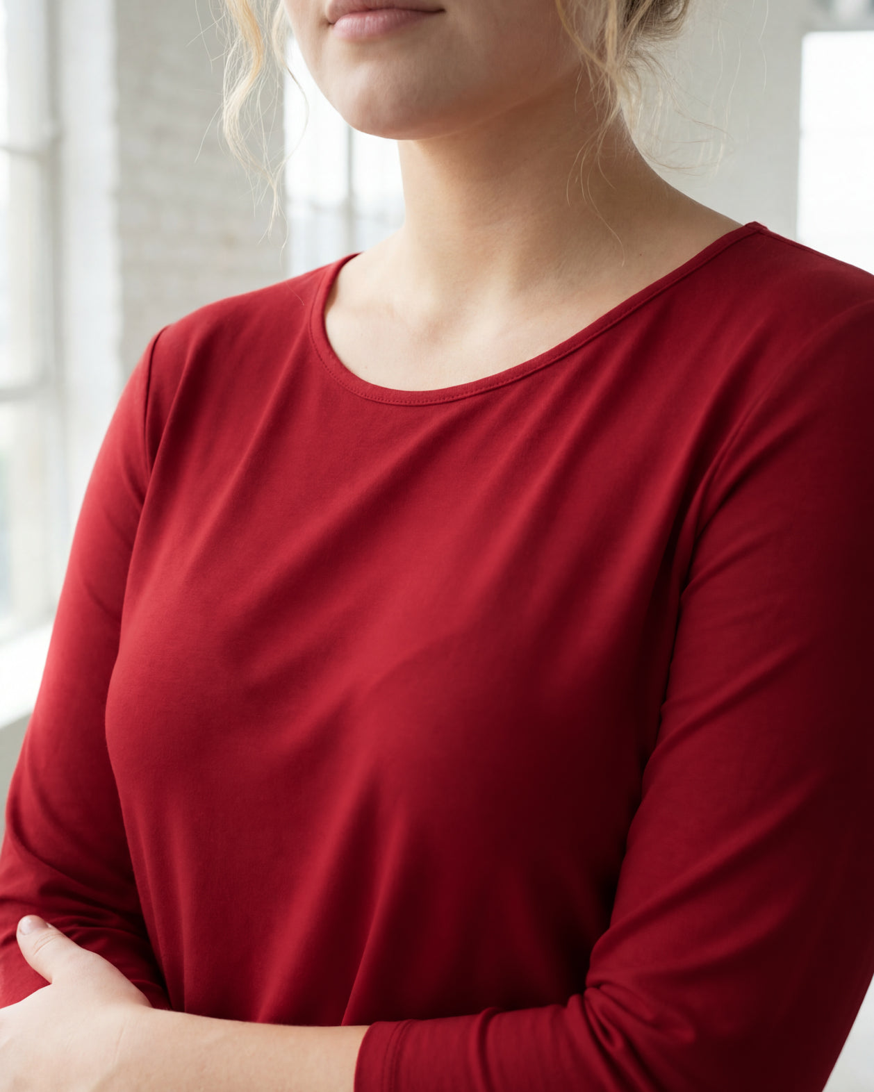 Model wearing Nuggles® 3/4 Essential Tee in Brick Red