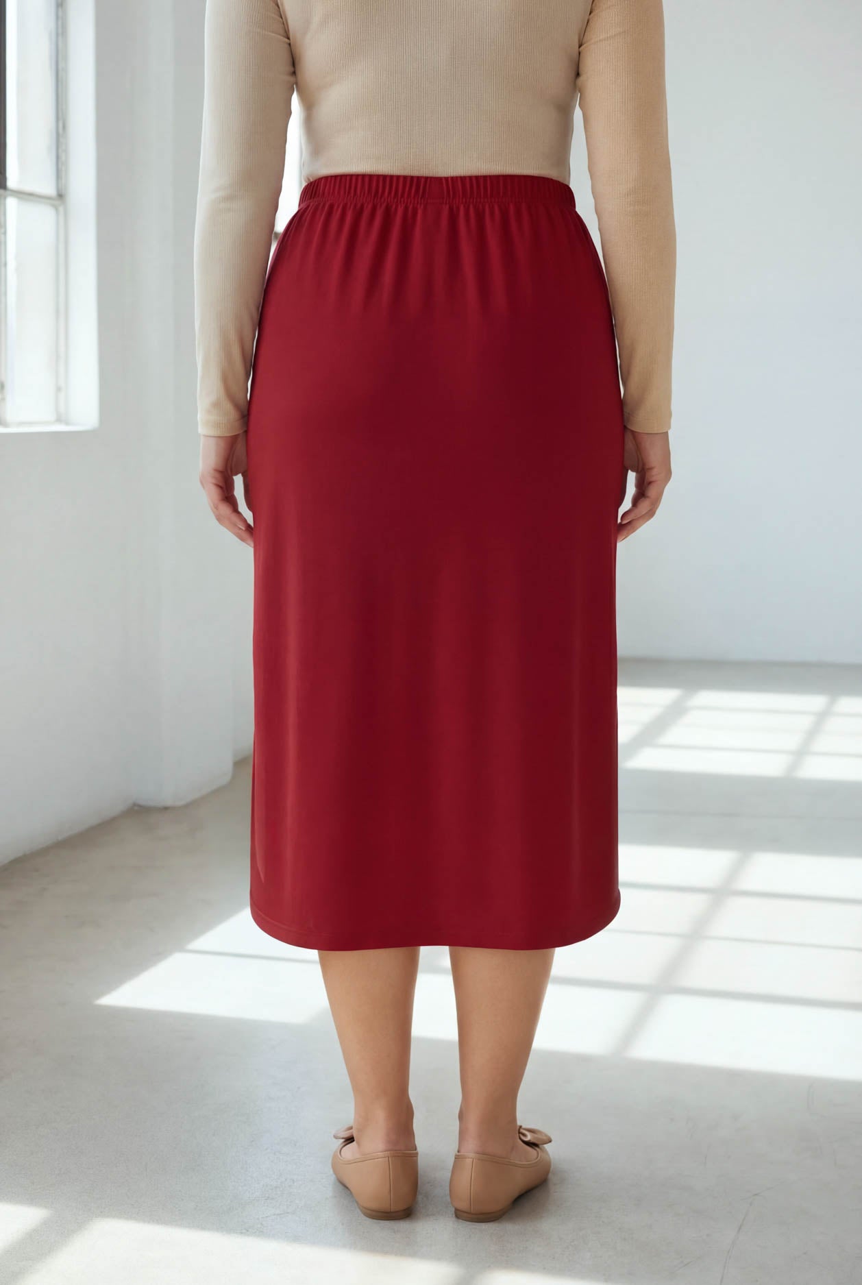 Model wearing Nuggles® 31" Classic Skirt in Brick Red