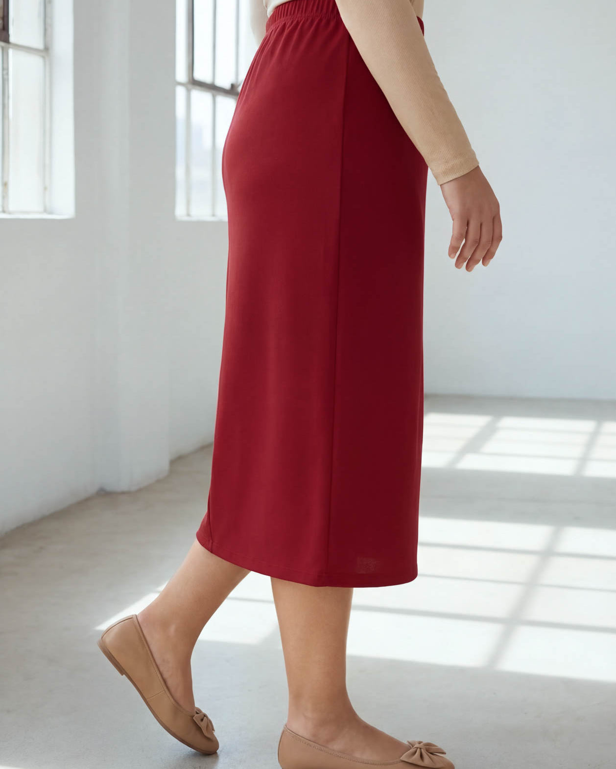 Model wearing Nuggles® 31" Classic Skirt in Brick Red