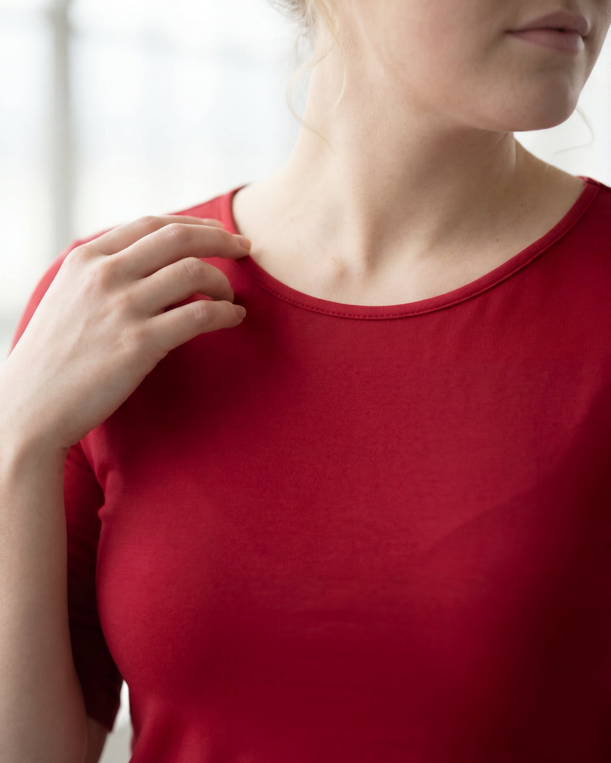 Model wearing Nuggles® Half Sleeve Essential Tee in Brick Red