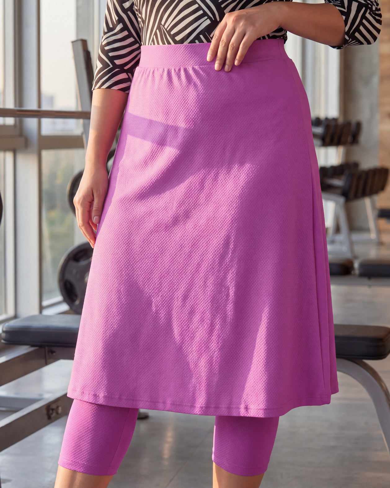 Model wearing Nuggles® 27" All-Sport Skirt in Bubble Gum